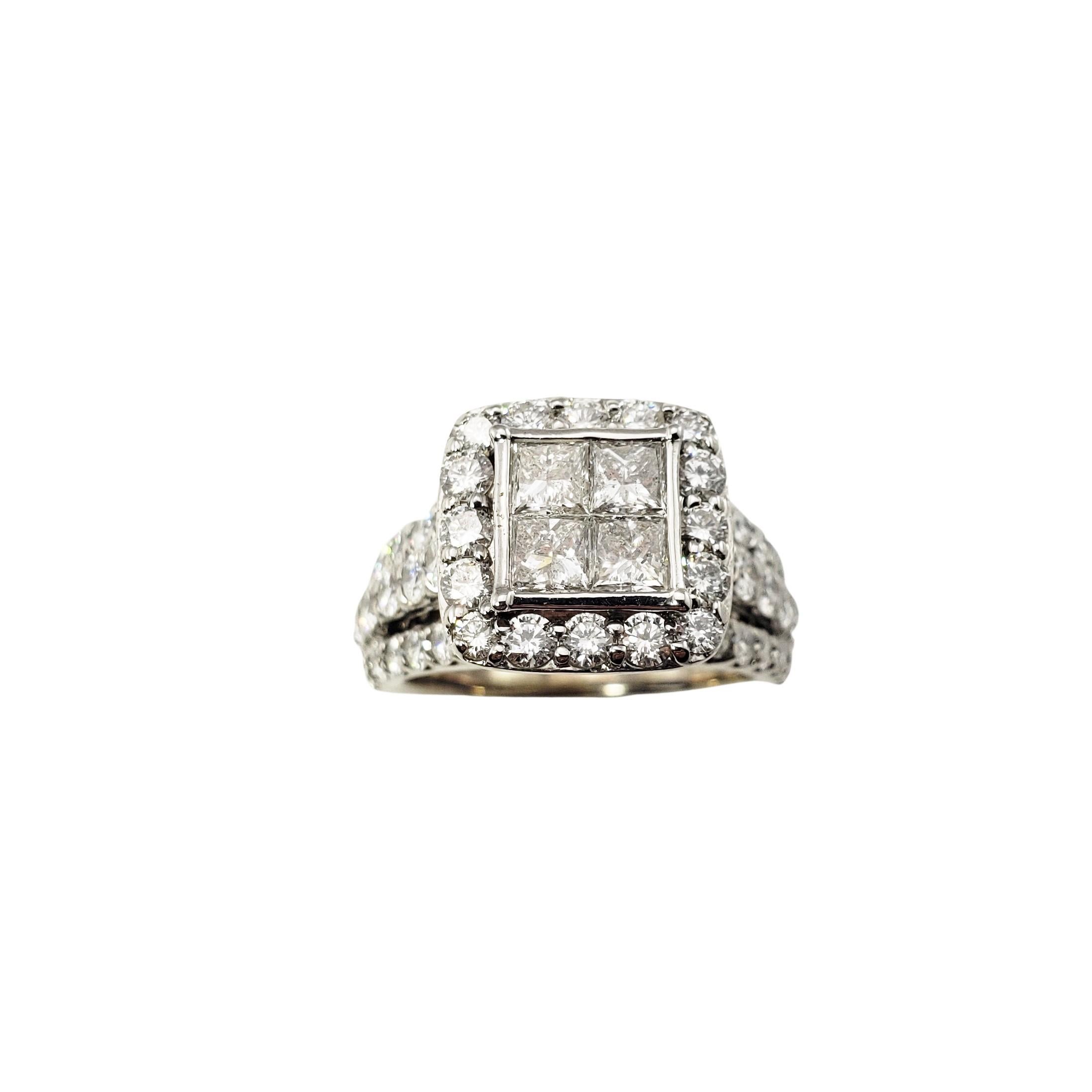 14 Karat White Gold and Diamond Ring Size 5.5-

This sparkling ring features four princess cut diamonds and 56 round brilliant cut diamonds set in beautifully detailed 14K white gold.  Width:  12 mm.  Height:  9 mm.  Shank:  2 mm.

Approximate total