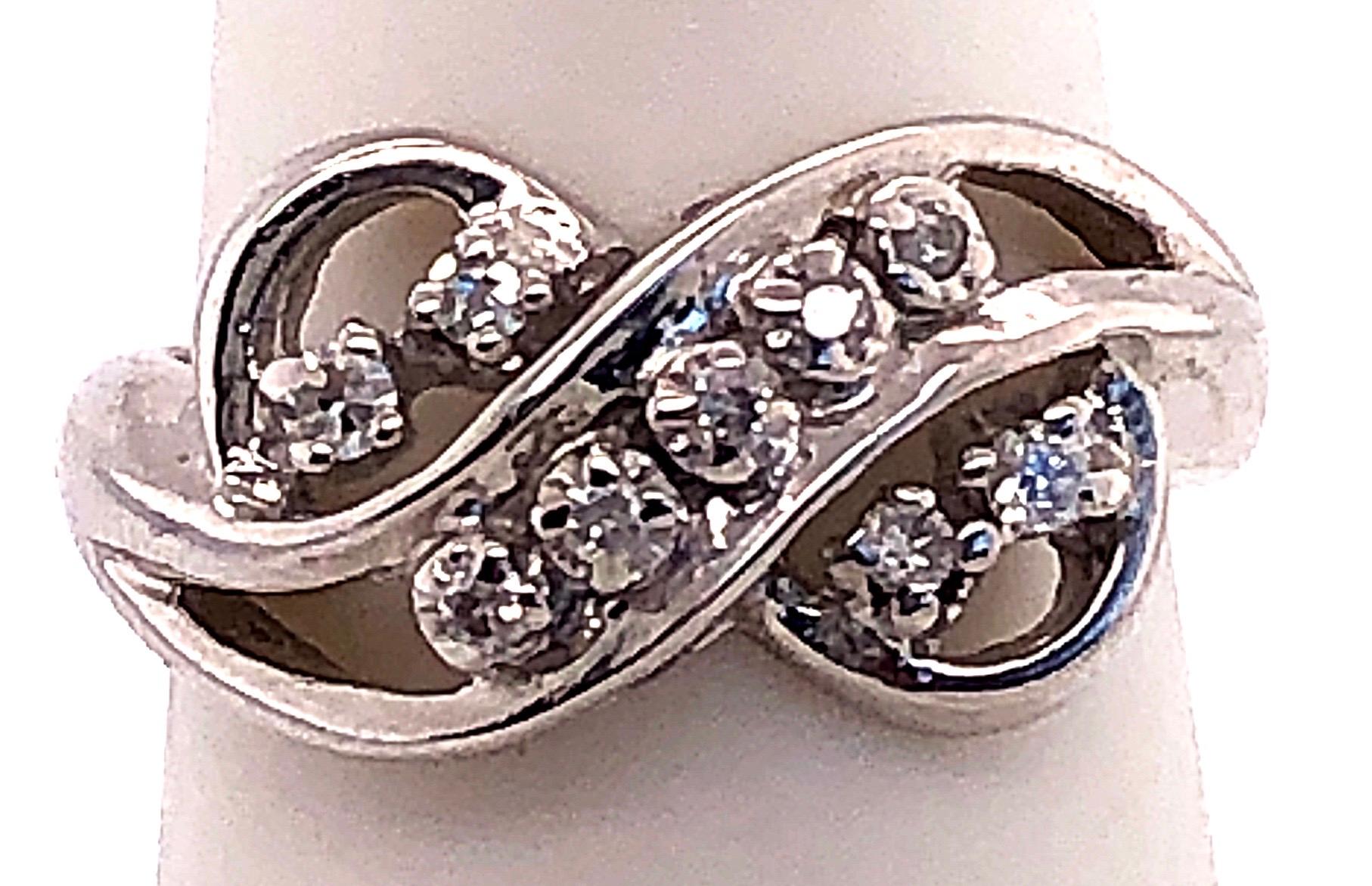 14 Karat White Gold And Diamond Swirl Ring
0.10 total diamond weight.
size 5
3.56 grams total weight.