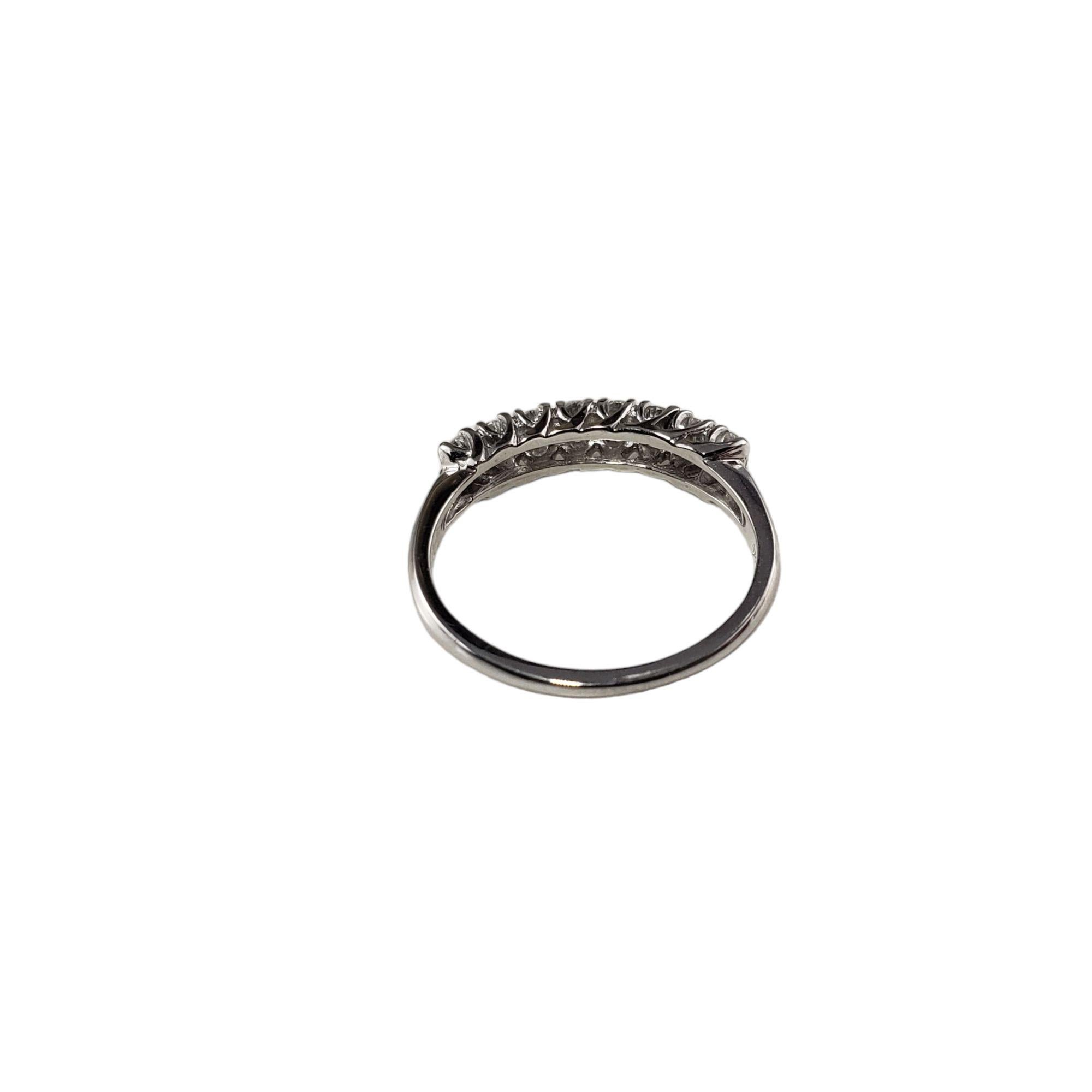 Vintage 14 Karat White Gold and Diamond Wedding Band Ring Size 6.25-6.5

This sparkling band features eight round brilliant cut diamonds set in classic 14K white gold. Width: 4 mm. Shank: 2 mm.

Approximate total diamond weight: .40 ct.

Diamond