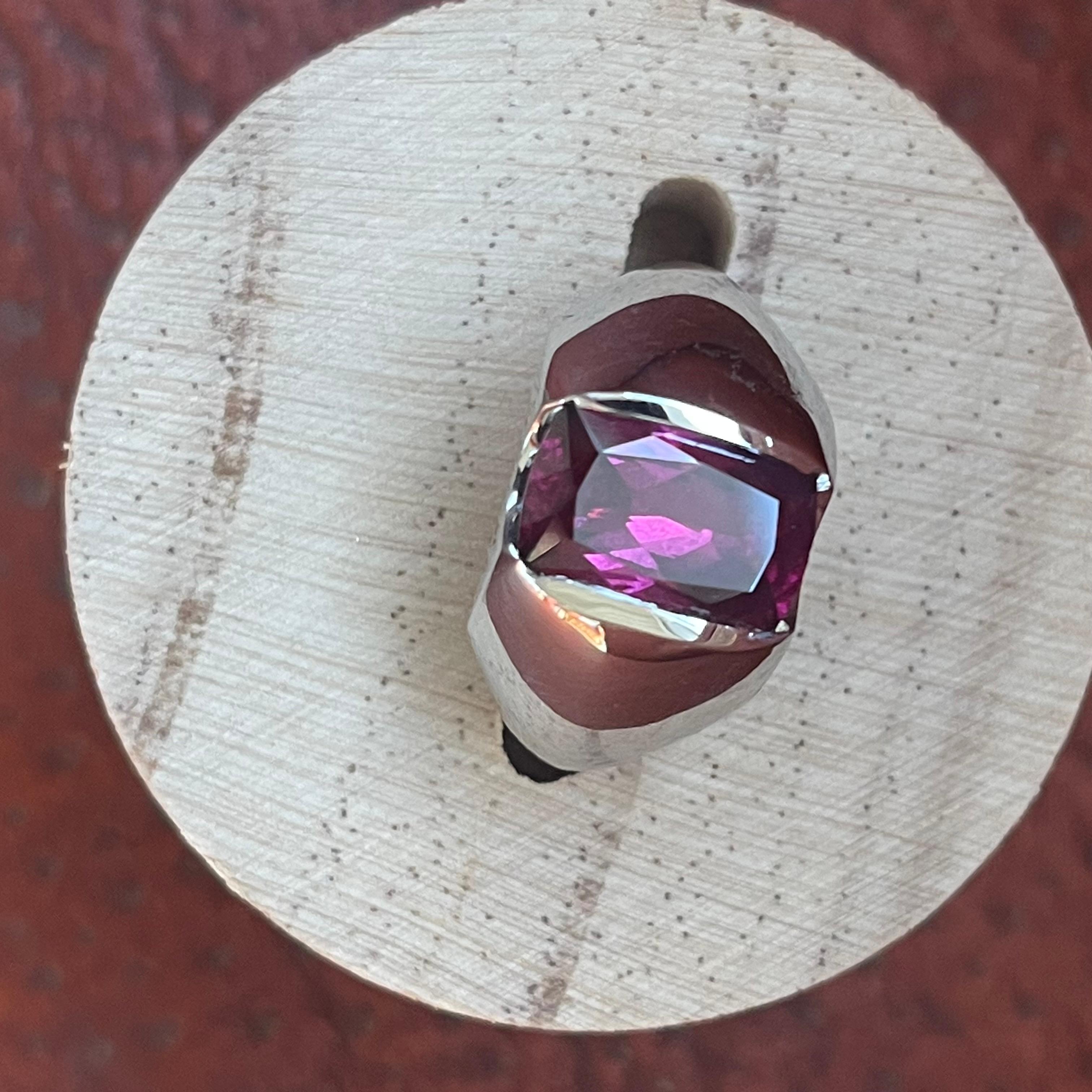 This Vance Gems design ring features a 4.03-carat, cushion-cut Rhodolite Garnet and is done in heavy 14-karat white gold. The half-bezel setting gives the stone enough light to make the purplish-red garnet sparkle. The euro shank stabilizes the ring