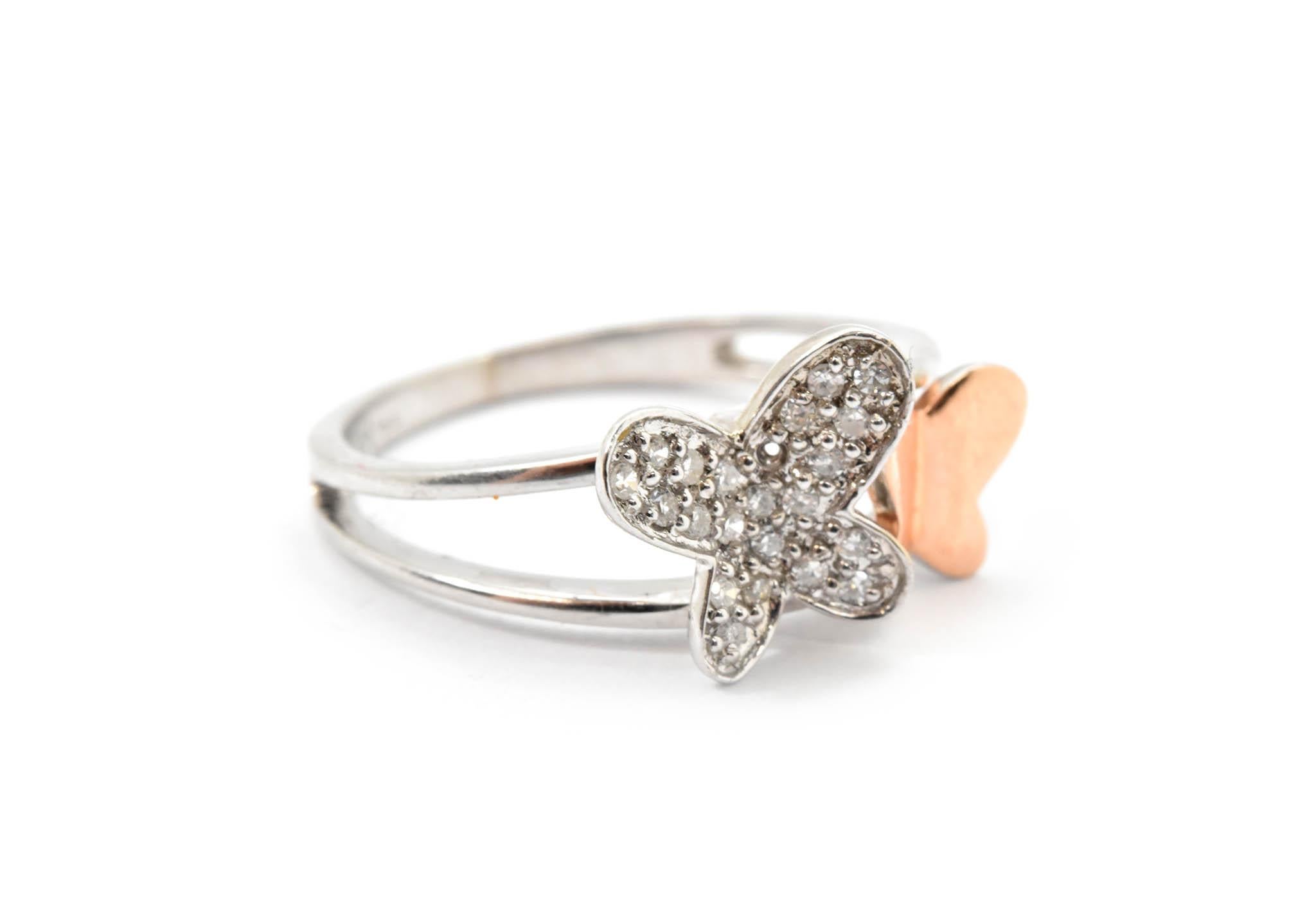 This is a creatively crafted ring that is composed of both 14k rose and white gold, the fashion ring features a butterfly in 14k rose gold and another diamond butterfly! 21 round diamonds are prong set in the 14k white gold mountings! Diamonds