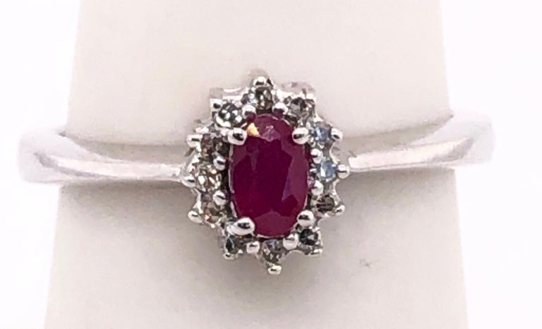 14 Karat White Gold and Ruby Ring Surrounded by Diamonds For Sale at