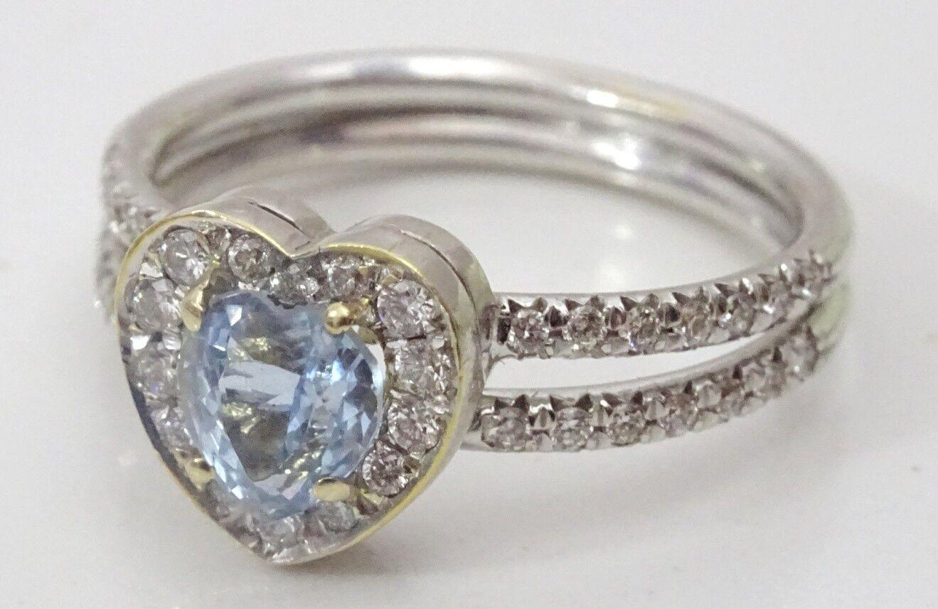 
A lovely Heart Shaped Ring , the center stone is  a 5 mm Heart Shaped Hand Cut and very vibrant Aquamarine , it is on a heart shaped base and surrounded by 18 1.5 mm round stones of 1.5 points each,
 The Shank is forked and on each of the forks