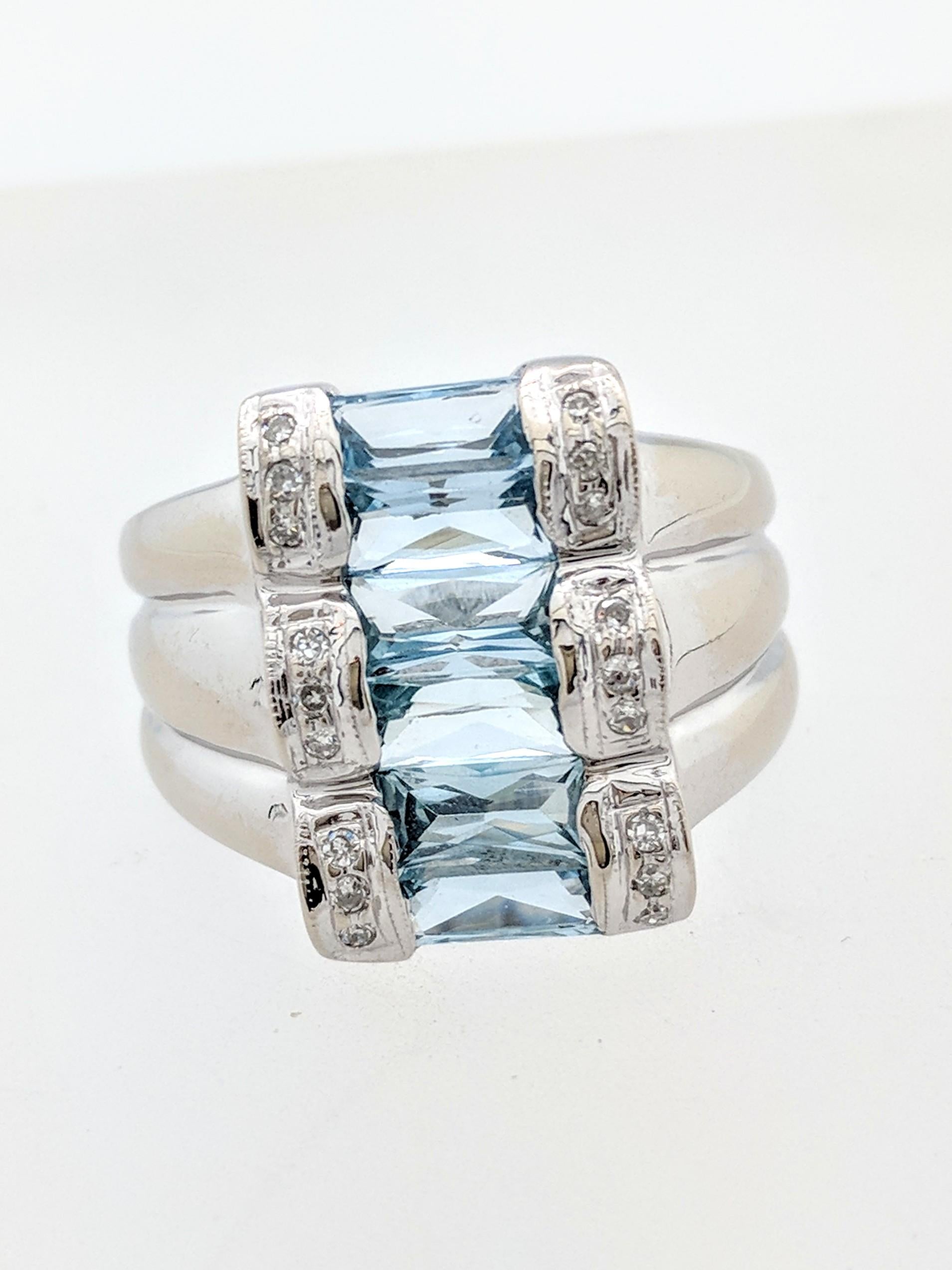 You are viewing a uniquely designed aquamarine & diamond ring.  This ring is crafted from 14k white gold and weighs 6.2 grams.  It features (6) sideways baguette shaped aquamarines and (18) .01ct natural round diamonds. Each aquamarine is