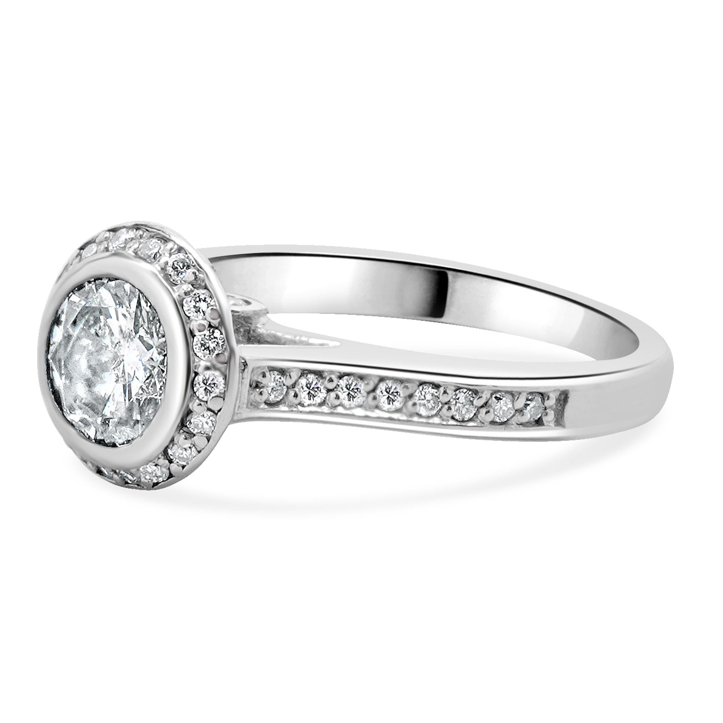Designer: custom design
Material: 14K white gold
Center Diamond: 1 round brilliant cut = 1.00ct
Color: I
Clarity: SI2
Diamonds: 34 round brilliant cut = 0.34cttw
Color: H
Clarity: SI1
Dimensions: ring top measures 9.4mm
Size: 5.75 complimentary