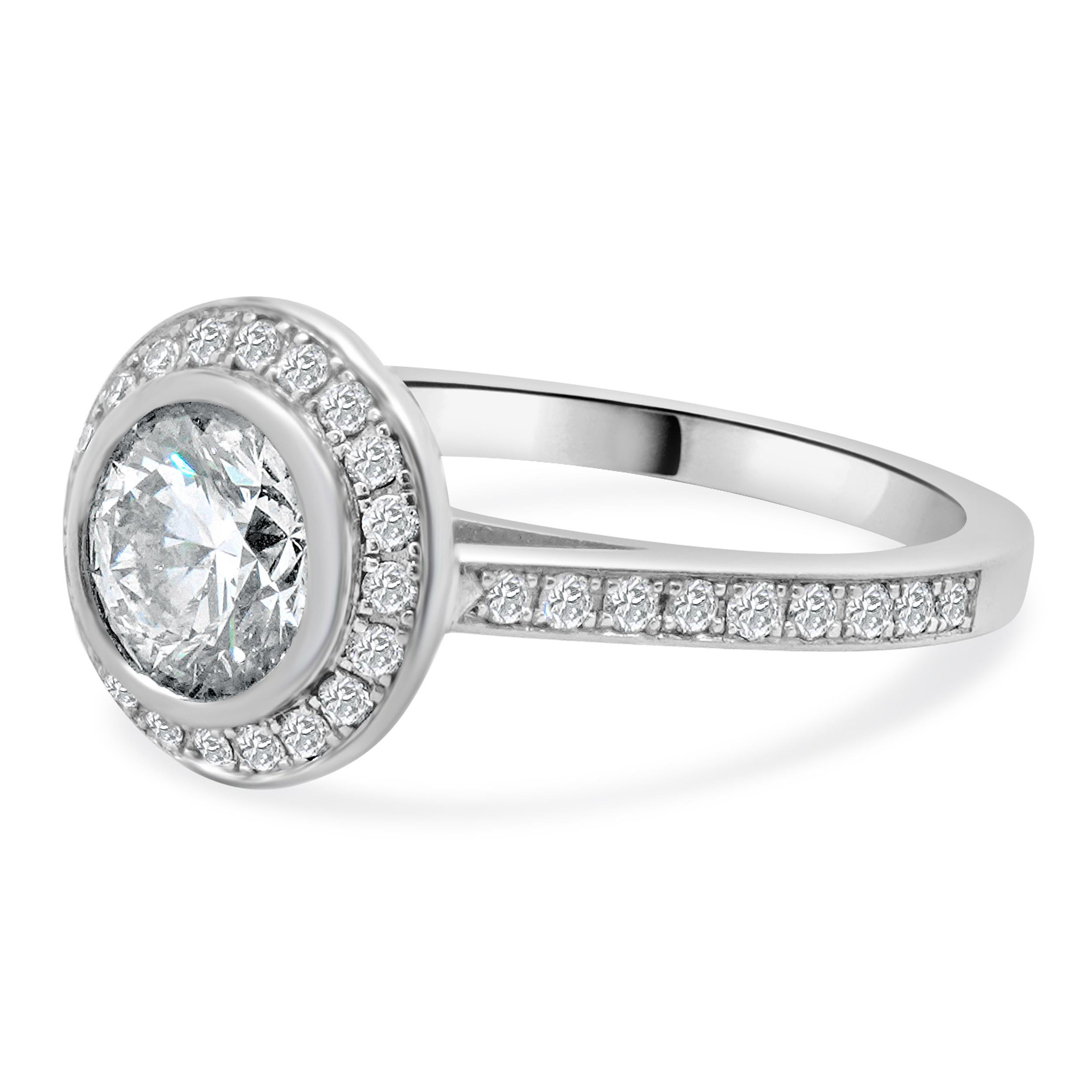 Designer: custom design
Material: 14K white gold
Center Diamond: 1 round brilliant = 1.15ct
Color : H
Clarity : I1
Diamond: round brilliant cut = 0.27cttw
Color : G
Clarity : SI1
Dimensions: ring top measures 10mm
Size: 4.75 complimentary sizing