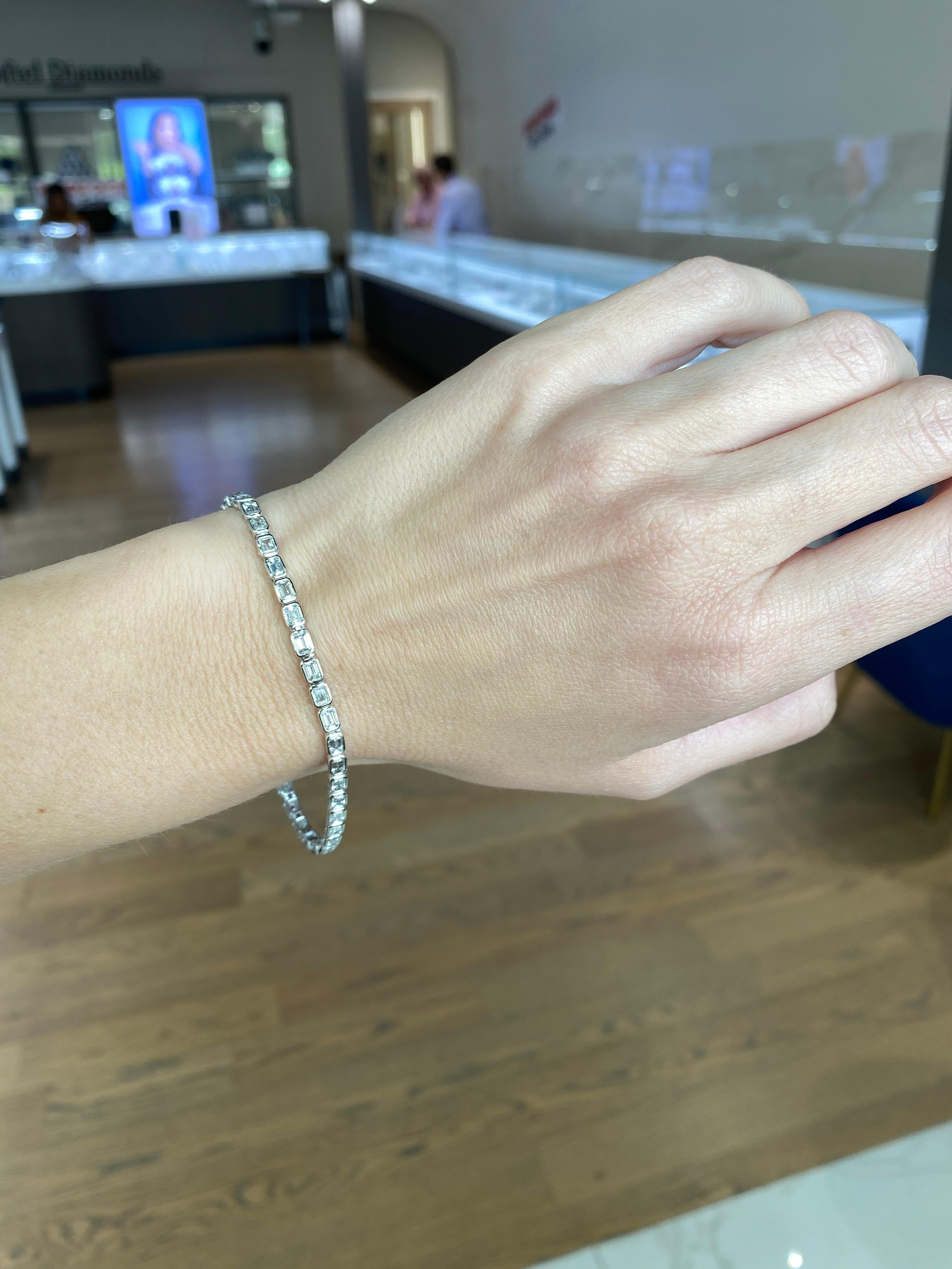 Elevate your wrist with this captivating bracelet, featuring a total of 4.70 carats of natural round diamonds expertly bezel set in luxurious polished 14 karat white gold. This elegant piece is designed for women and measures 7 inches in length,