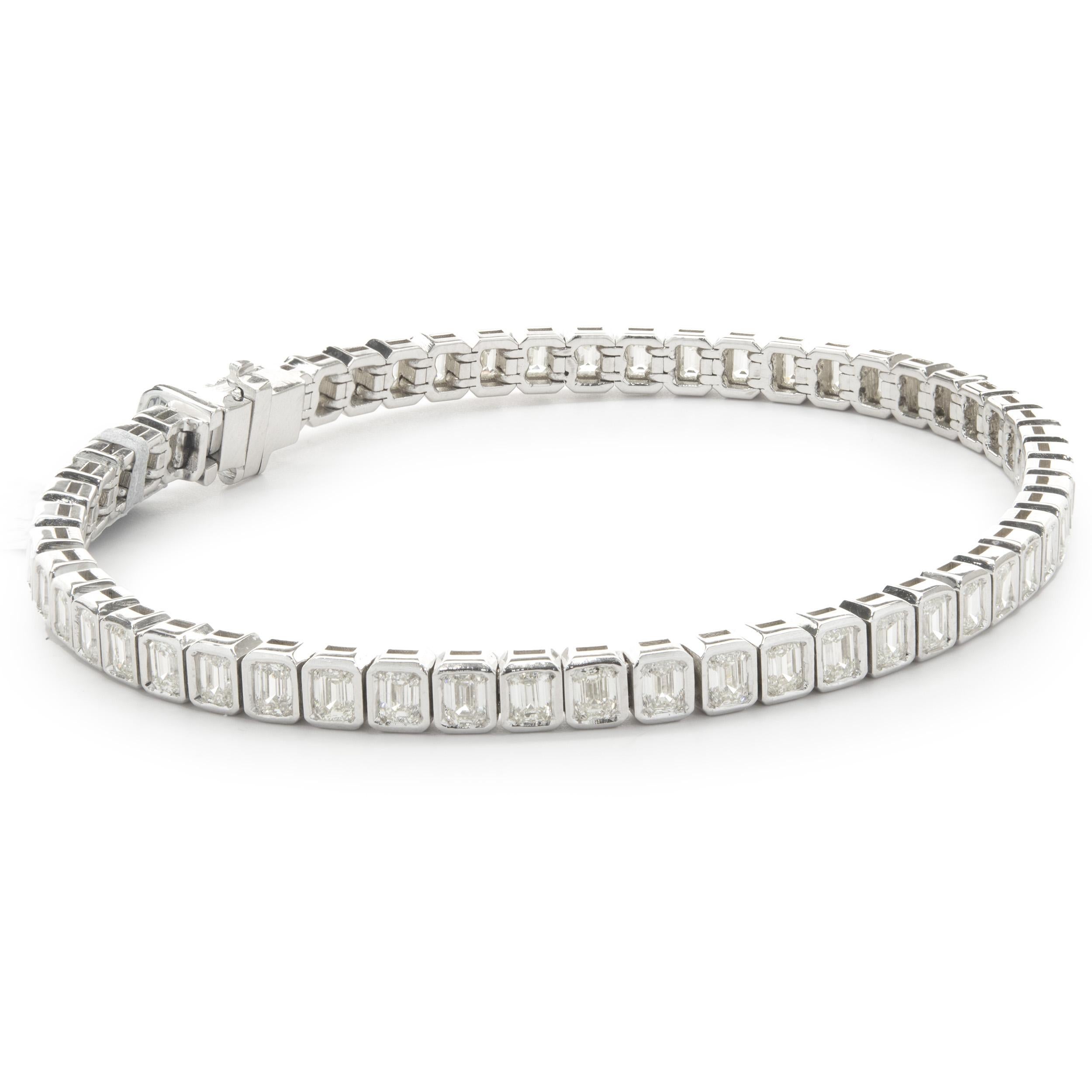 Designer: custom design
Material: 14K white gold
Diamonds: emerald cut = 5.05cttw
Color: I
Clarity: SI1
Dimensions: bracelet will fit up to a 7-inch wrist
Weight: 15.06 grams
