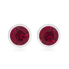 14 Karat White Gold Bezel Set Ruby Stud Earrings Weighing 0.30 Carat