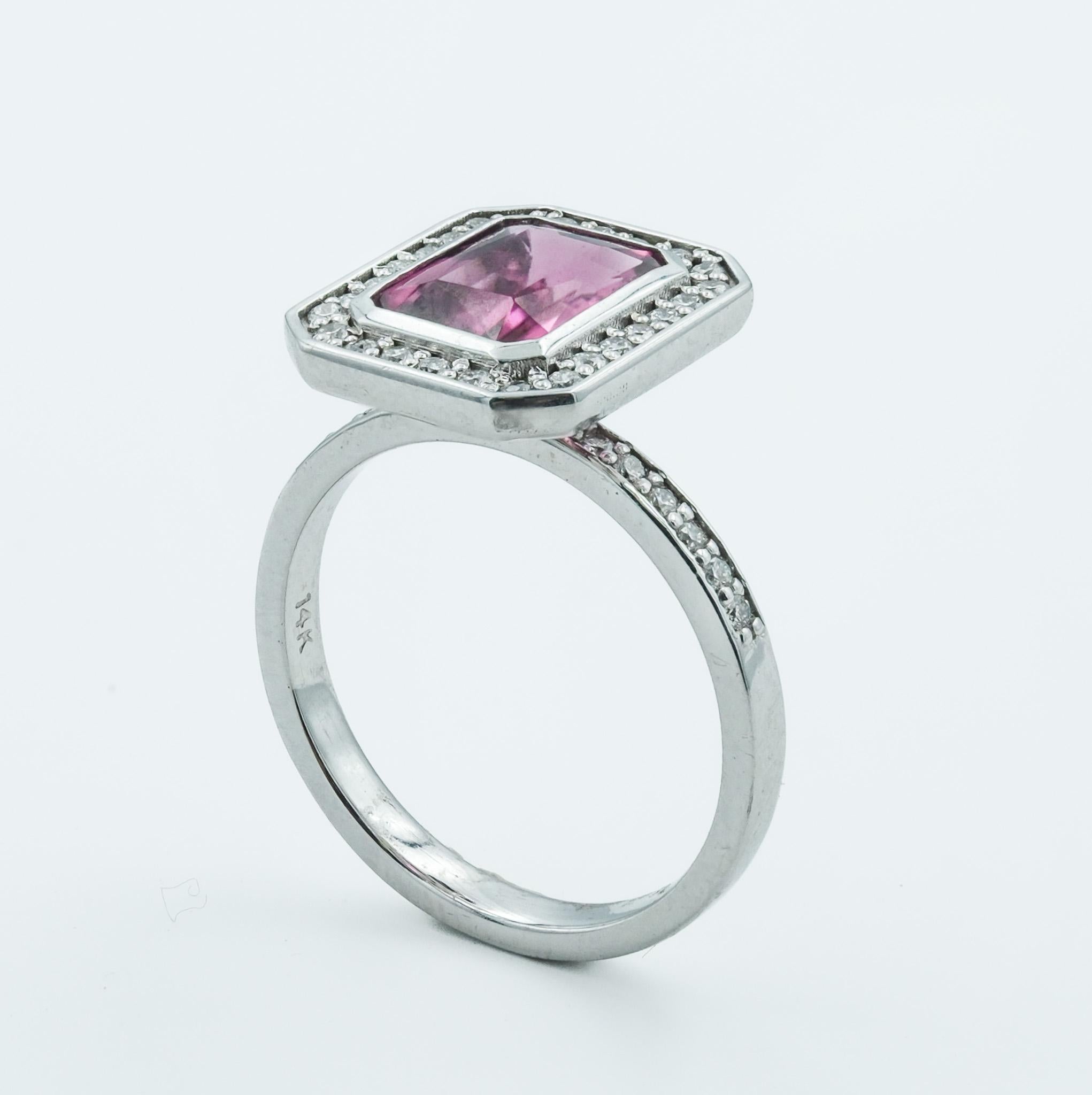 Crafted with precision, this ring is a paragon of classic design, featuring a 1.75 carat faceted bezel set tourmaline as its centerpiece. The tourmaline's rich color is encapsulated in a 14 karat white gold setting, which reflects a timeless sense
