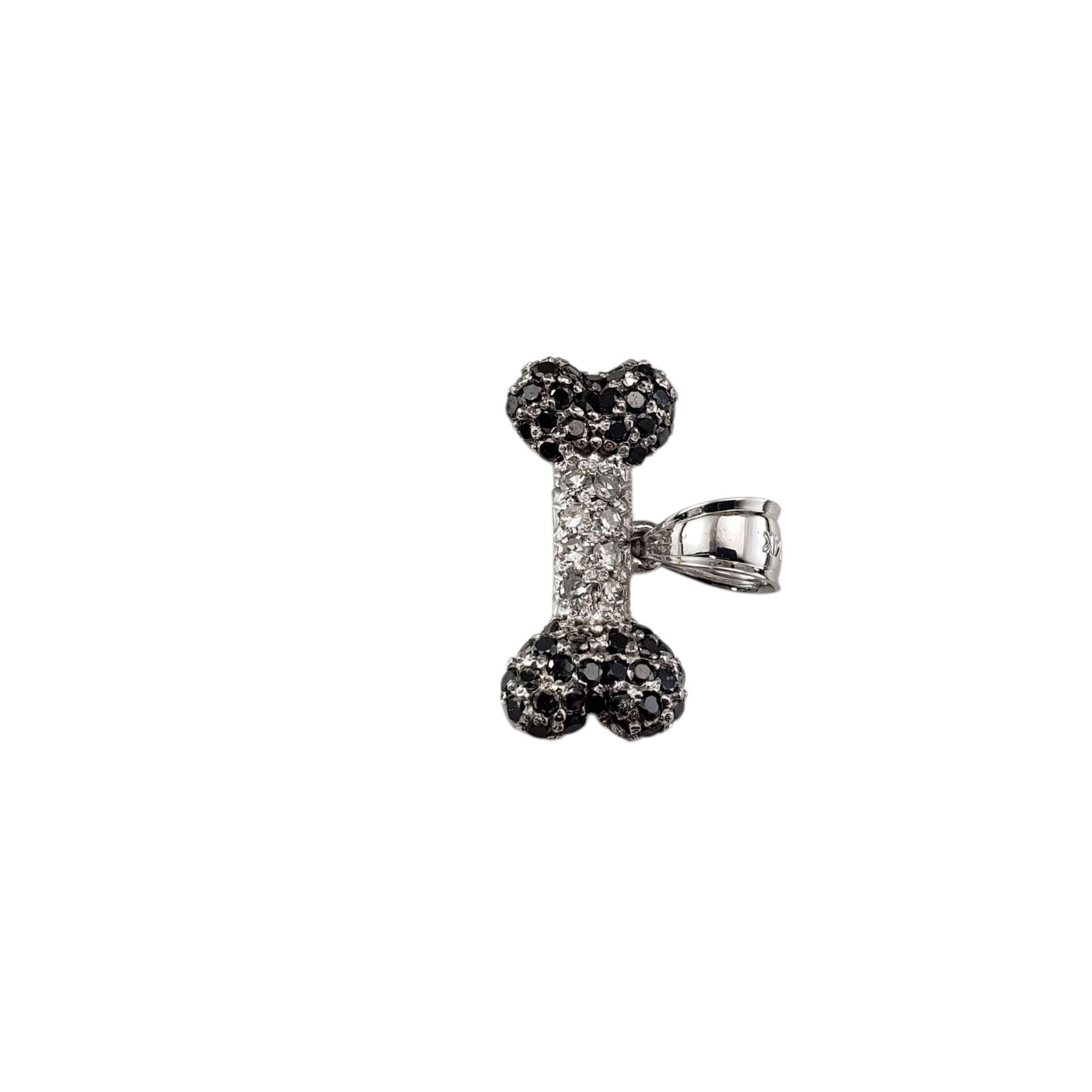 14 Karat White Gold Black and White Diamond Dog Bone Charm-

Crafted in elegant 14K white gold, this dog bone charm sparkles with a striking contrast of black (50) and white (8) single cut diamonds, creating a playful yet luxurious piece. A must for
