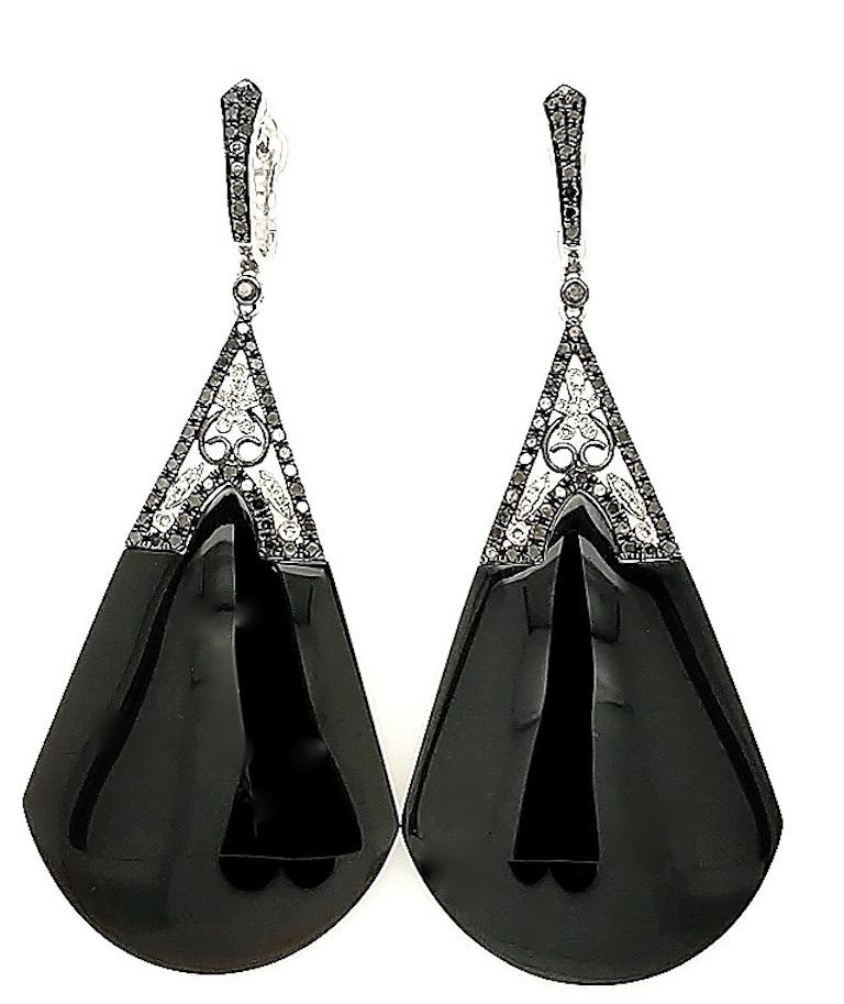 Crafted in 14k white gold featuring Black and white diamonds with Black onyx. The earrings measure 2 1/2