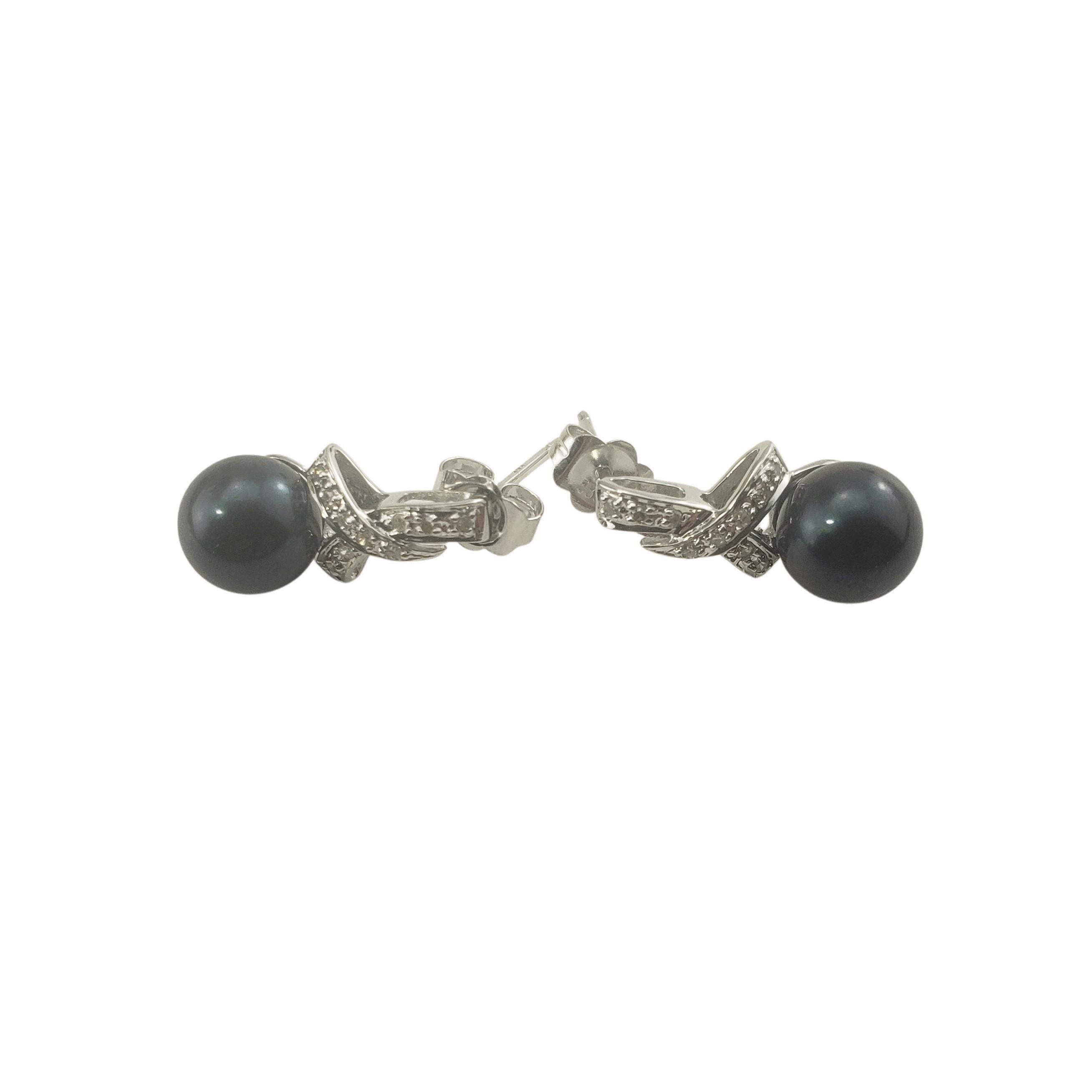 14 Karat White Gold Black Pearl and Diamond Drop Earrings-

These lovely drop earrings each feature one round black pearl (7 mm each) and ten round single cut diamonds set in classic 14K white gold.

Approximate total diamond weight:  .08