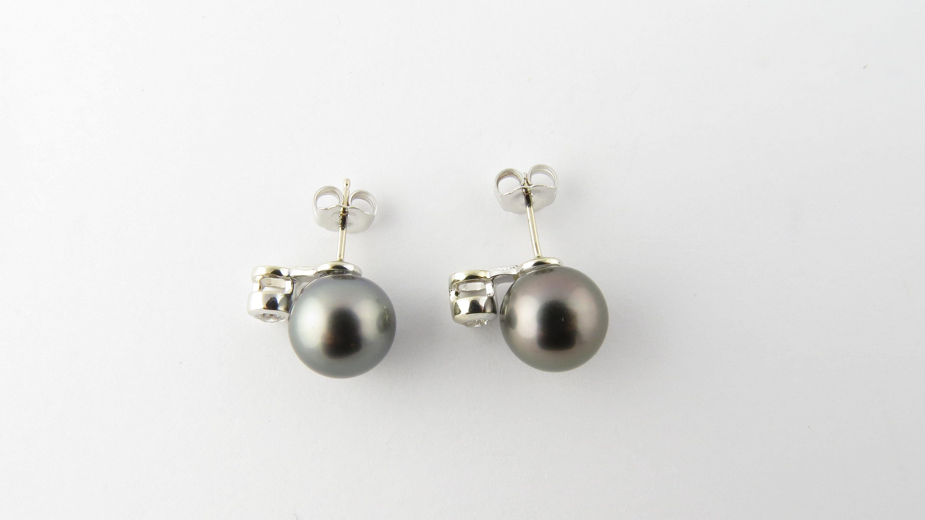 Vintage 14 Karat White Gold Black Pearl and Diamond Earrings-

These stunning earrings each feature one 10 mm black pearl and one round brilliant cut diamond set in beautifully detailed 14K white gold. Push back closures. 
Matching necklace: