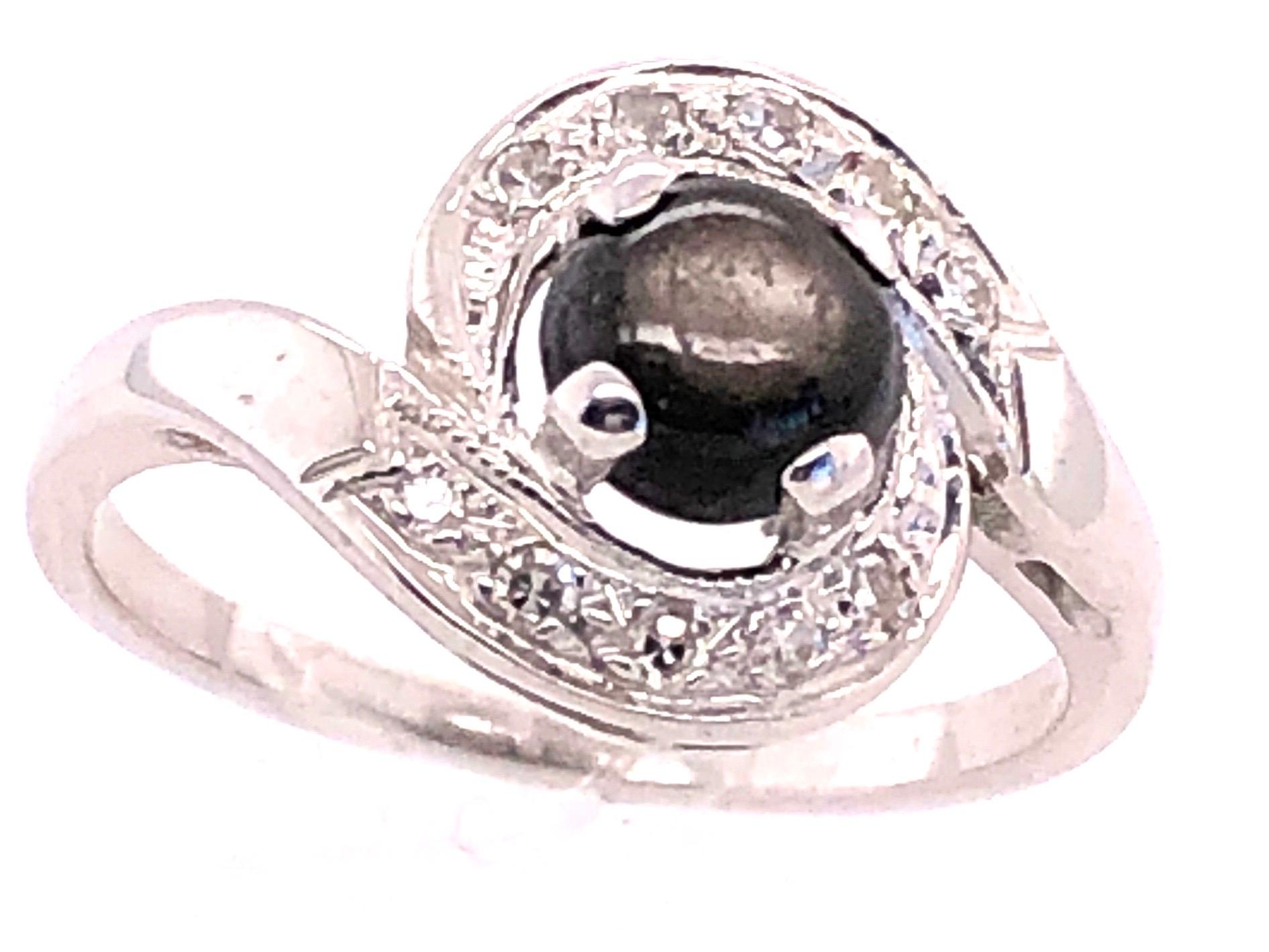 14 Karat white Gold Black Sapphire Contemporary Ring with Diamond Accents  
0.10 Total Diamond Weight
Size 6
3 grams total weight.