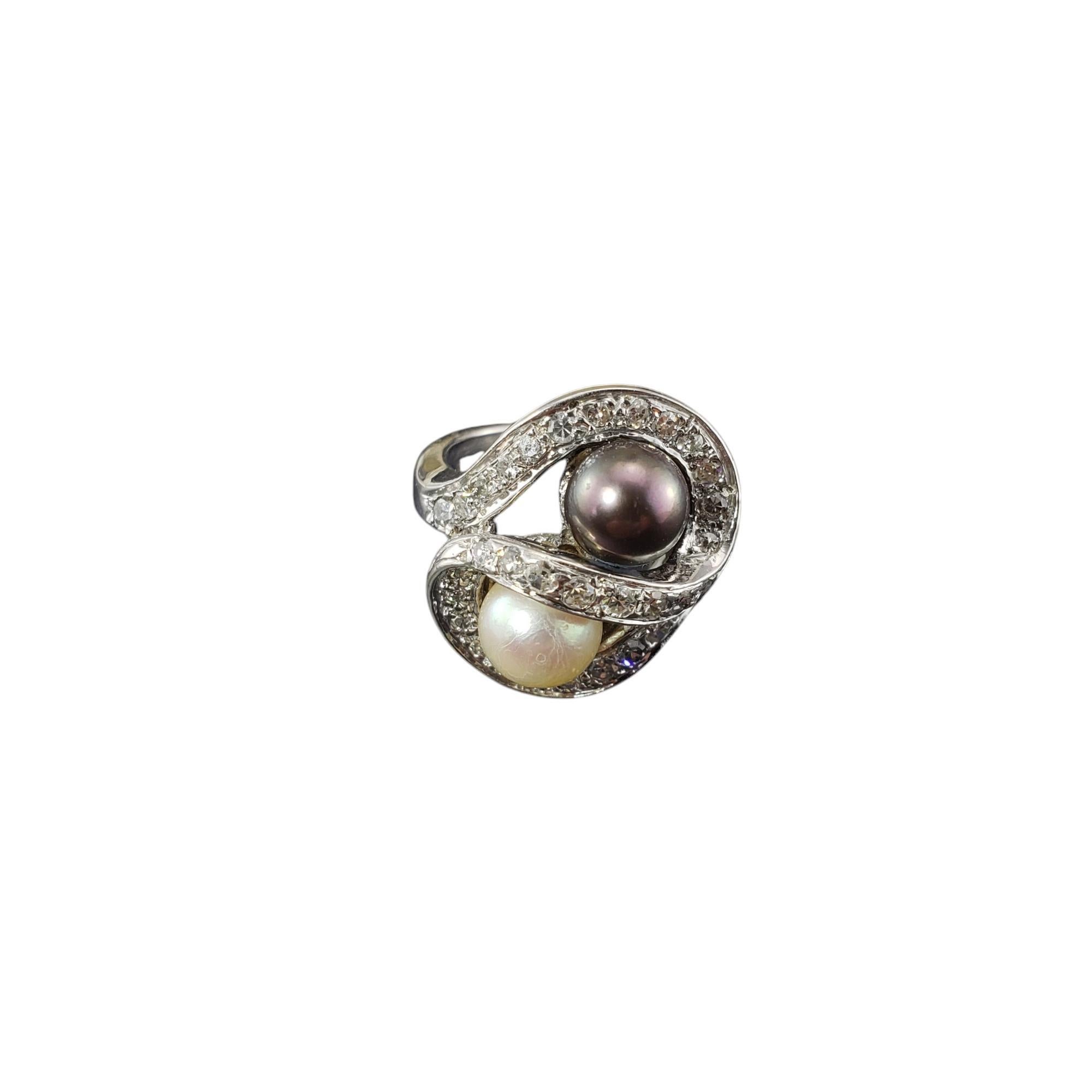14 Karat White Gold Black & White Pearl and Diamond Ring Size 4.5-

This lovely ring features one black pearl (6 mm) and one white pearl (6 mm) accented with 33 single cut diamonds set in 14K white gold. 

Width: 18 mm. Shank: 2 mm.

Approximate