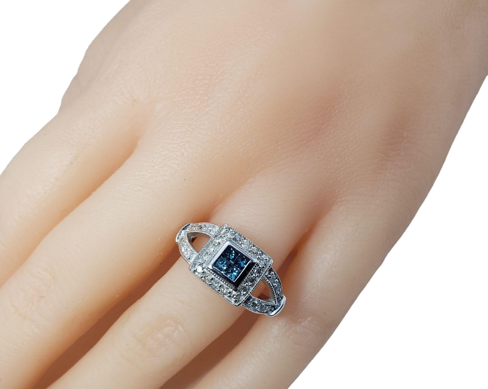 Vintage 14 Karat White Gold Blue (Color Treated) and White Diamond Ring Size 7-

This sparkling ring features four blue color treated princess cut diamonds and 31 round single cut diamonds set in classic 14K white gold. Width: 10 mm. Shank: 3