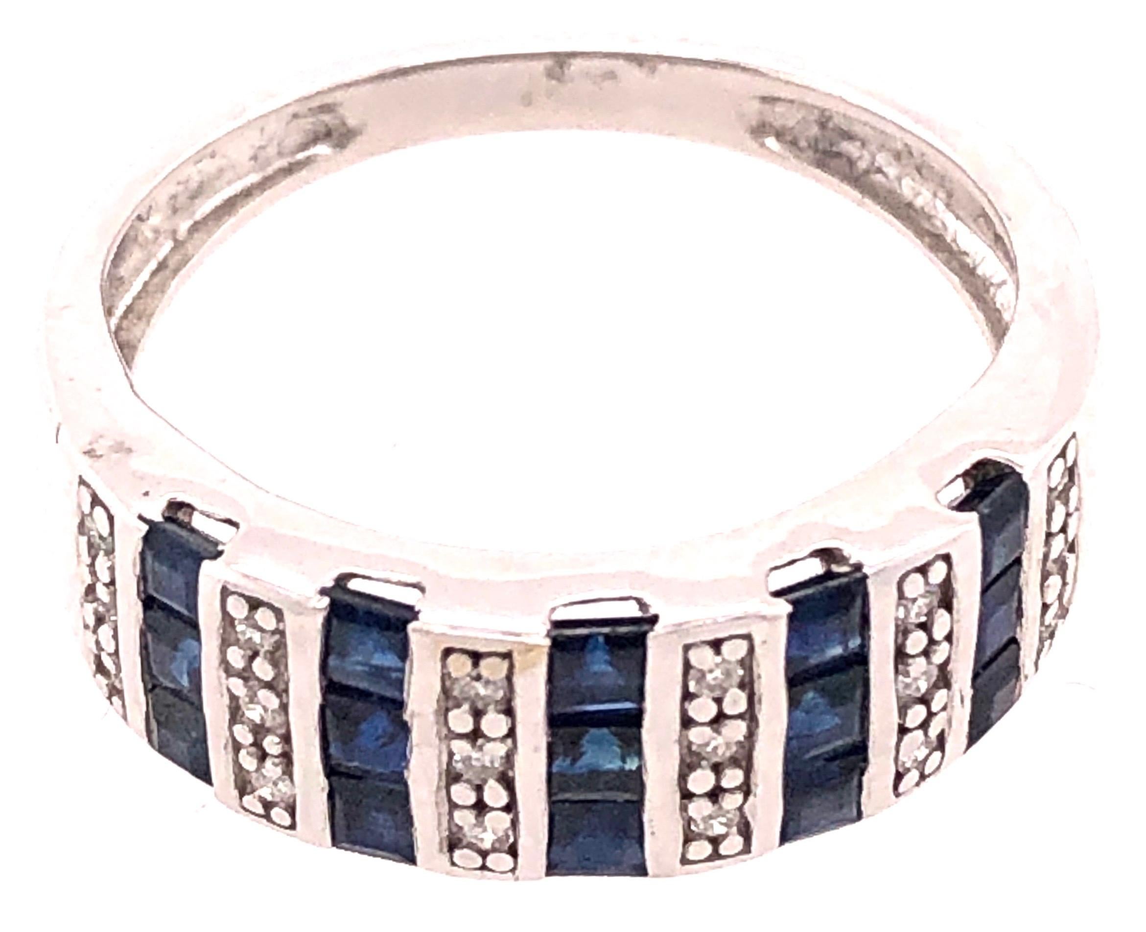 14 Karat White Gold Blue Sapphire And Diamond Band Ring
0.18 TDW.
Size 7.25
4 grams total weight.