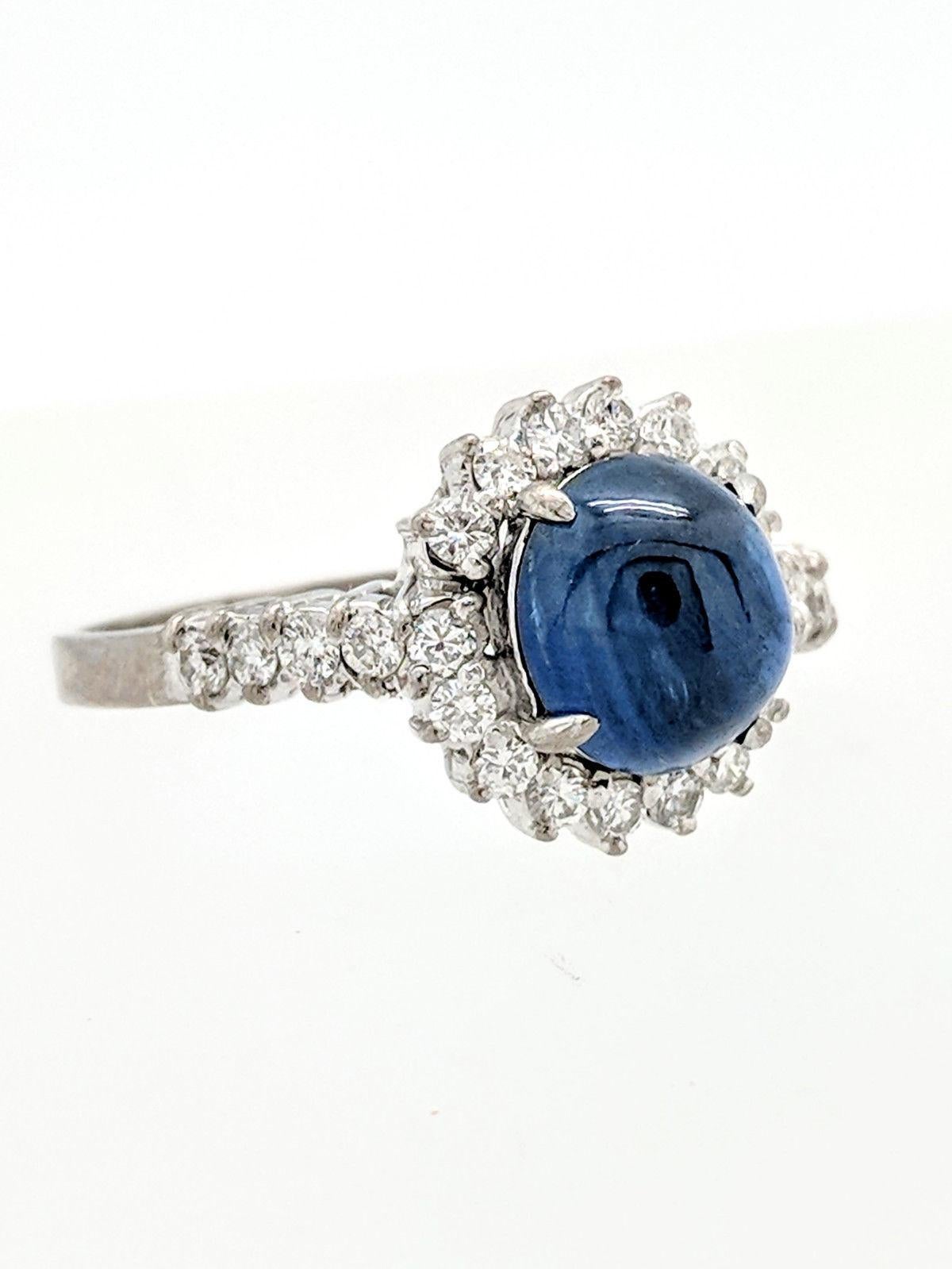 You are viewing a beautiful Estate Blue Star Sapphire and Diamond Halo Ring. Any woman would love to add this piece to their collection! 

This ring is crafted from 14k white gold and weighs 4.4 grams. It features one (1) 8x7mm natural oval shaped