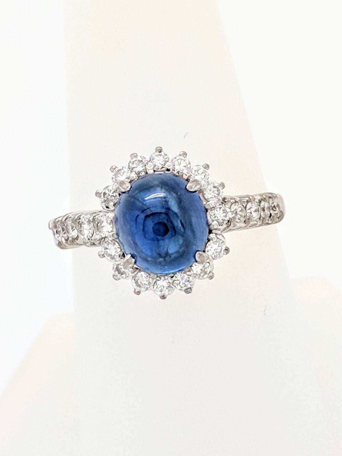 Oval Cut 14 Karat White Gold Blue Star Sapphire and Diamond Halo Ring