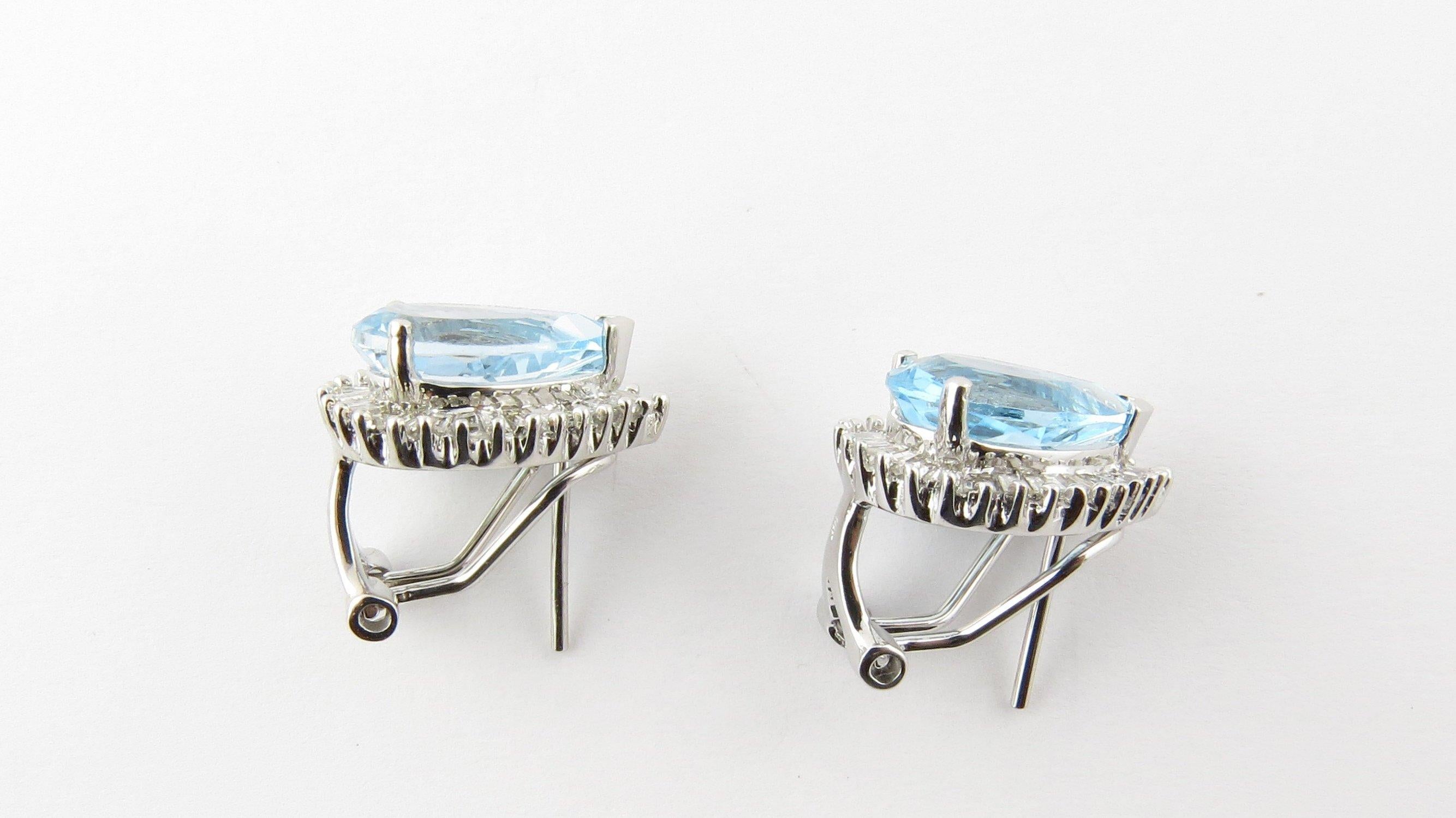 Vintage 14 Karat White Gold Blue Topaz and Diamond Earrings-

These gorgeous earrings each feature one pear-shaped blue topaz (approx. 12 mm x 8 mm) surrounded by 28 baguette diamonds set in classic 14K white gold.

Approximate total diamond weight: