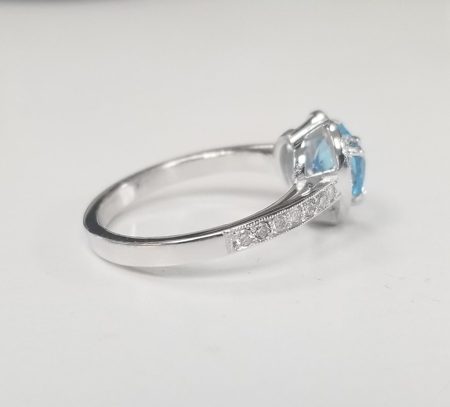 14k white gold Blue Topaz and Diamond Heart halo Ring, containing 1 heart shape cut pink sapphire of gem quality weighing 1.40cts. and 33 round full cut diamonds of very fine quality weighing .33pts.  This ring is a size 6.75 but we will size to fit