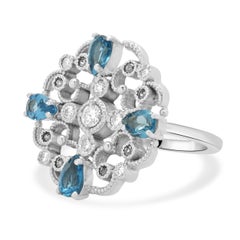 14 Karat White Gold Blue Topaz, Sapphire, and Diamond Flower Ring