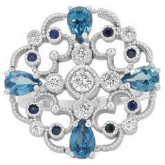 14 Karat White Gold Blue Topaz, Sapphire, and Diamond Flower Ring