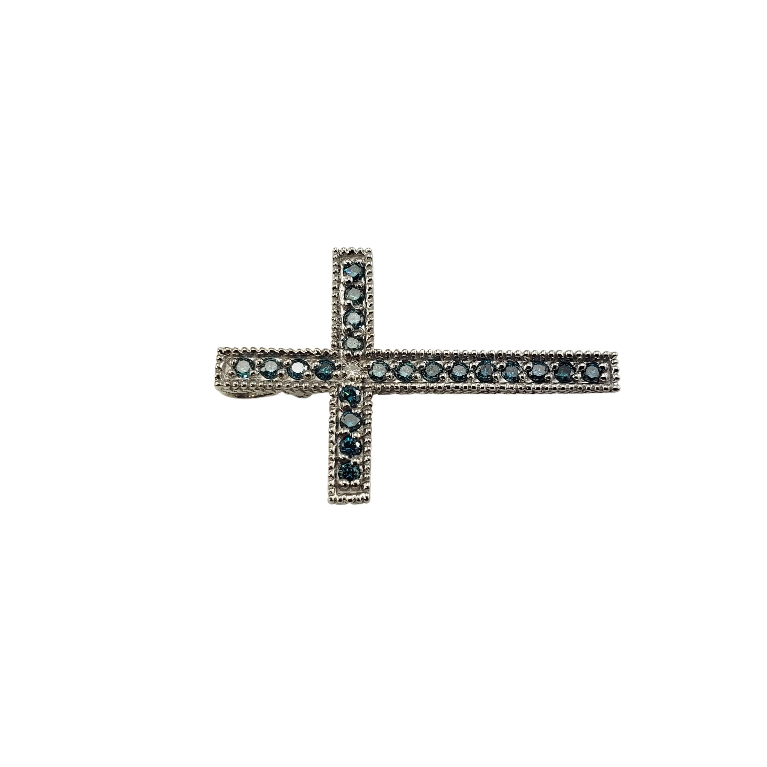 14 Karat White Gold and Blue Treated Diamond Cross Pendant-

This sparkling cross pendant features one white round brilliant cut diamond and 21 blue treated round brilliant cut diamonds set in classic 14K white gold.

Approximate total diamond