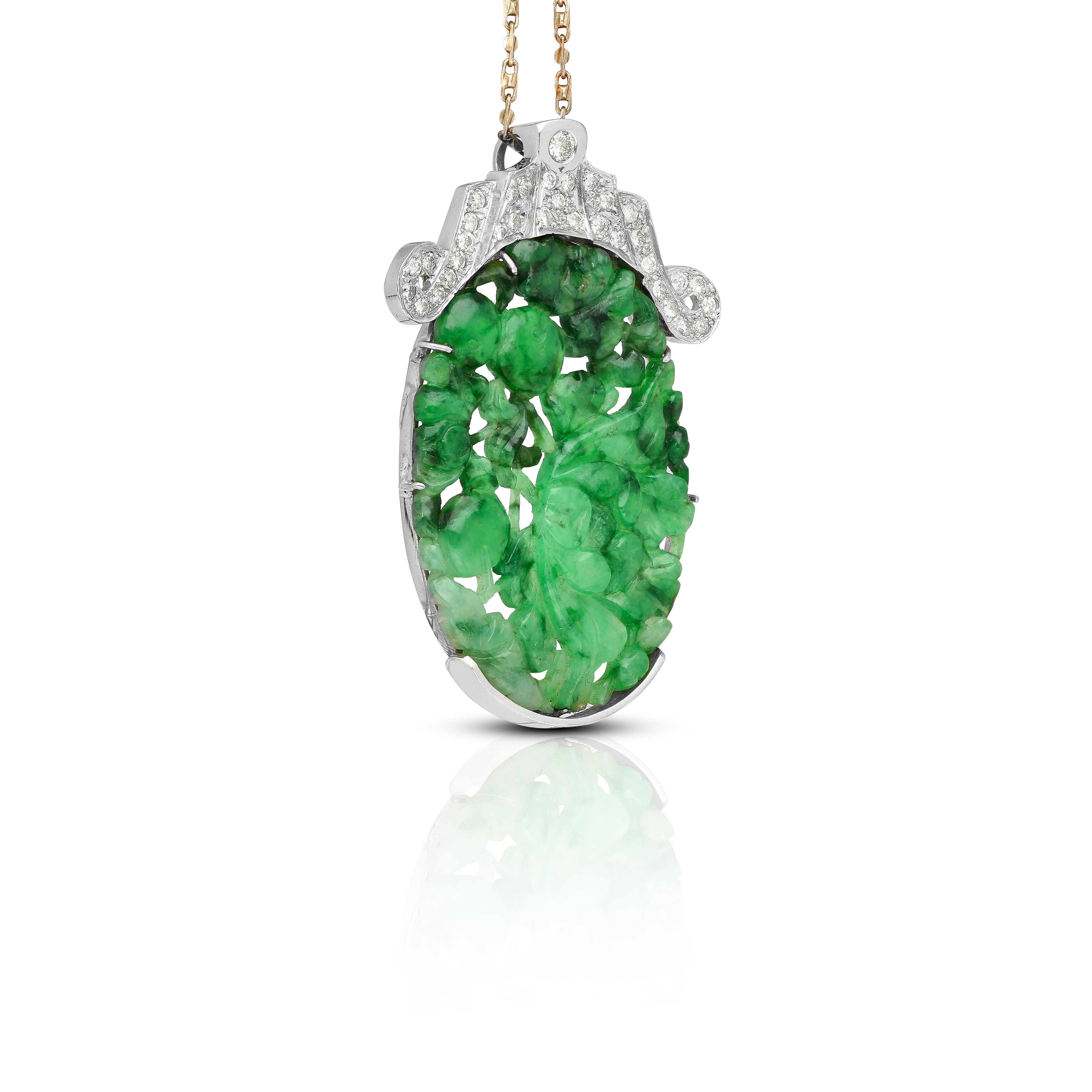 This 14K White Gold Necklace, features a stunning combination of carved 'A' grade jade and white diamonds.

The centerpiece of this necklace is intricately carved jadeite jade, complemented by 34 round cut diamonds, totaling 0.80 carats, and weighs