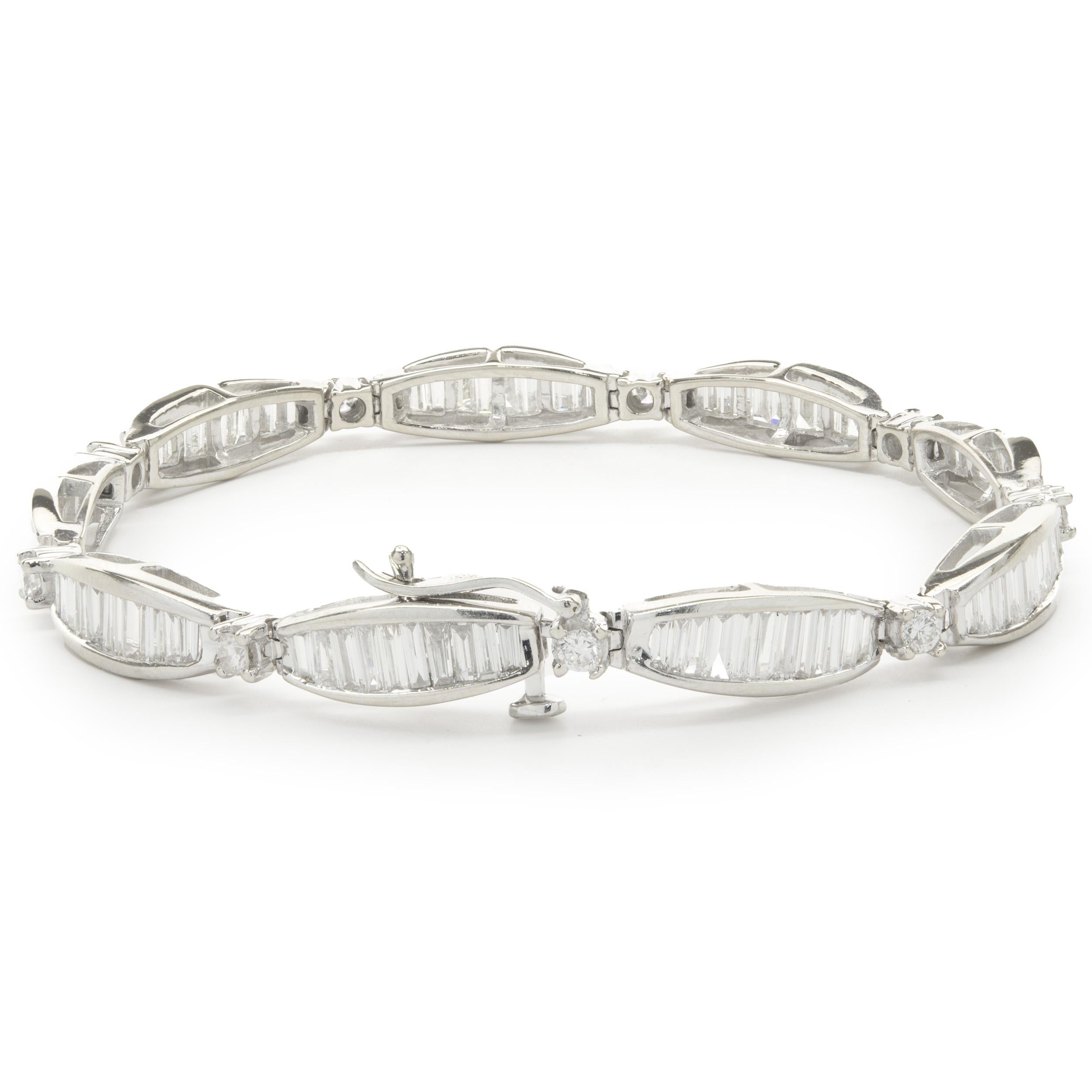 Designer: custom design
Material: 14K white gold
Diamond: 99 baguette cut = 8.50cttw
Color: H / I
Clarity: SI1
Diamond: 9 round brilliant cut = 0.50cttw
Color: H
Clarity: SI1
Dimensions: bracelet measures 7-inches in length
Weight: 17.50 grams