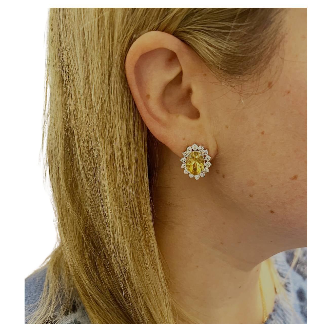 14 Karat White Gold Citrine & Natural Diamond Halo Earrings 
Metal: 14k white gold
Weight: 8.47 grams
Diamonds: Approx. 1.40 CTW G-H SI round natural diamonds
Citrine: 9 x 11mm
Dimensions: 18 x 15.5mm
Backs: Lever backs with posts
