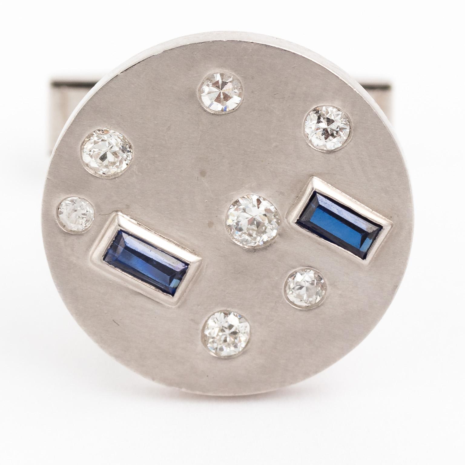 Circa 1970s white 14 karat gold cufflinks with approximately 0.50 pts of diamonds and 0.40 pts of Blue Sapphires. Brushed gold with hand finishing. Made in the United States. 