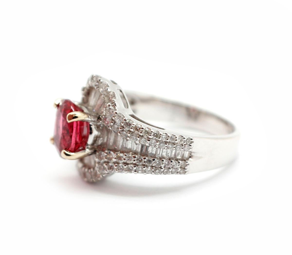 This ring is made in 14k white gold, and it holds a faceted, oval-cut red spinel at its center weighing 1.60ct. The spinel is accented by an additional 1.51 carats of diamonds for some more sparkle. The ring measures 14mm wide, and it weighs 6.3