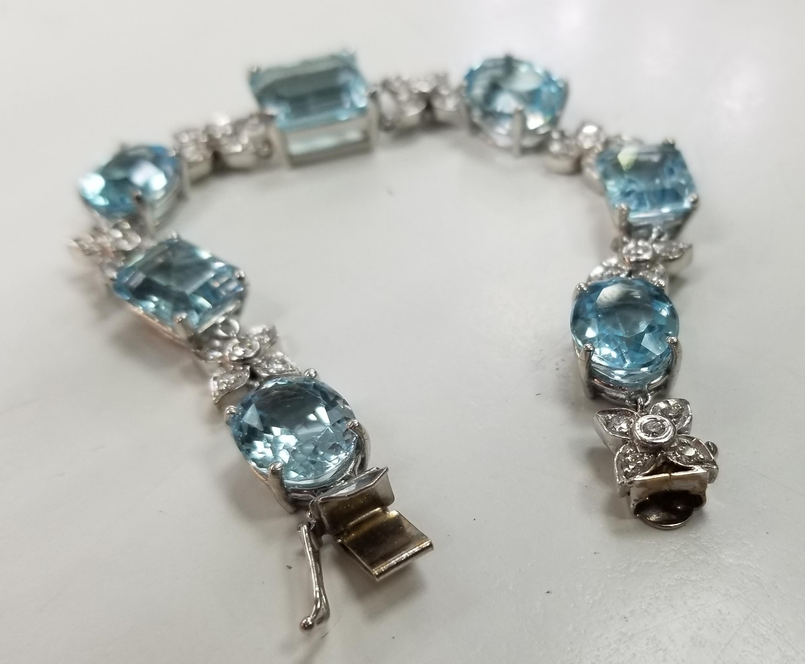 14 karat white gold Diamond and Blue Topaz bracelet, containing 35 round full cut diamonds; color 
