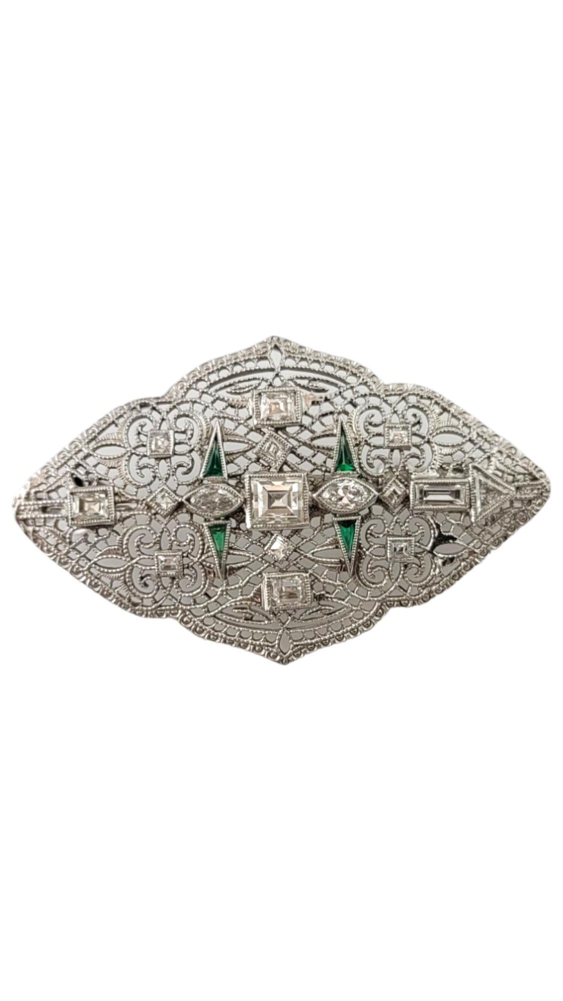 Vintage 14 Karat White Gold Diamond and Emerald Pendant/Brooch-

This exquisite piece features 16 diamonds: 12 square cut, 1 baguette, 2 marquis, and 1 trillion. Accented with four triangular genuine emeralds. Beautifully set in delicate 14K white