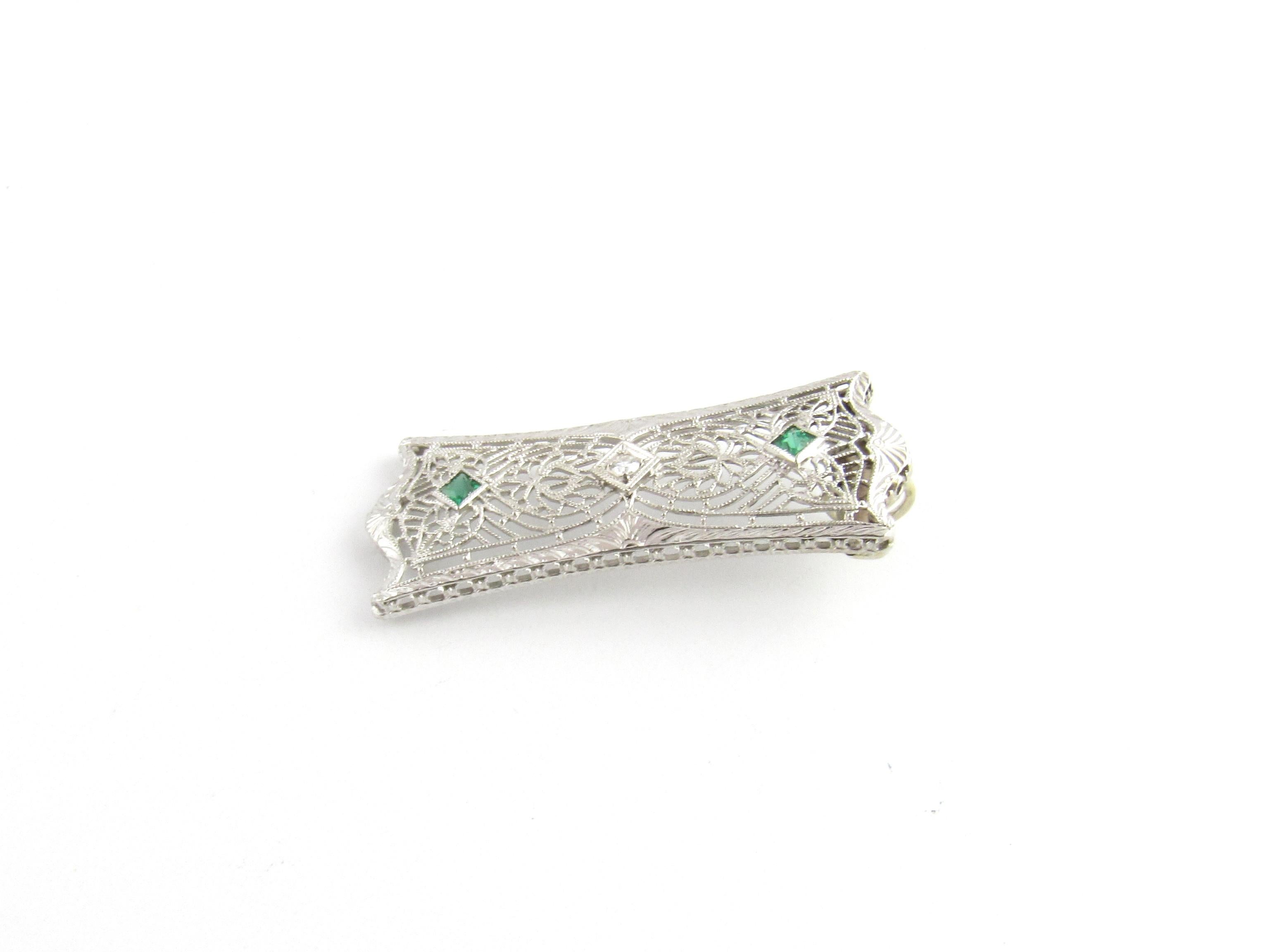 14 Karat White Gold Diamond and Emerald Pendant-

This lovely pendant features one single cut diamond and two genuine emeralds set in beautifully detailed white gold filigree.

Approximate total diamond weight: .03 ct.

Diamond clarity: SI1
Diamond