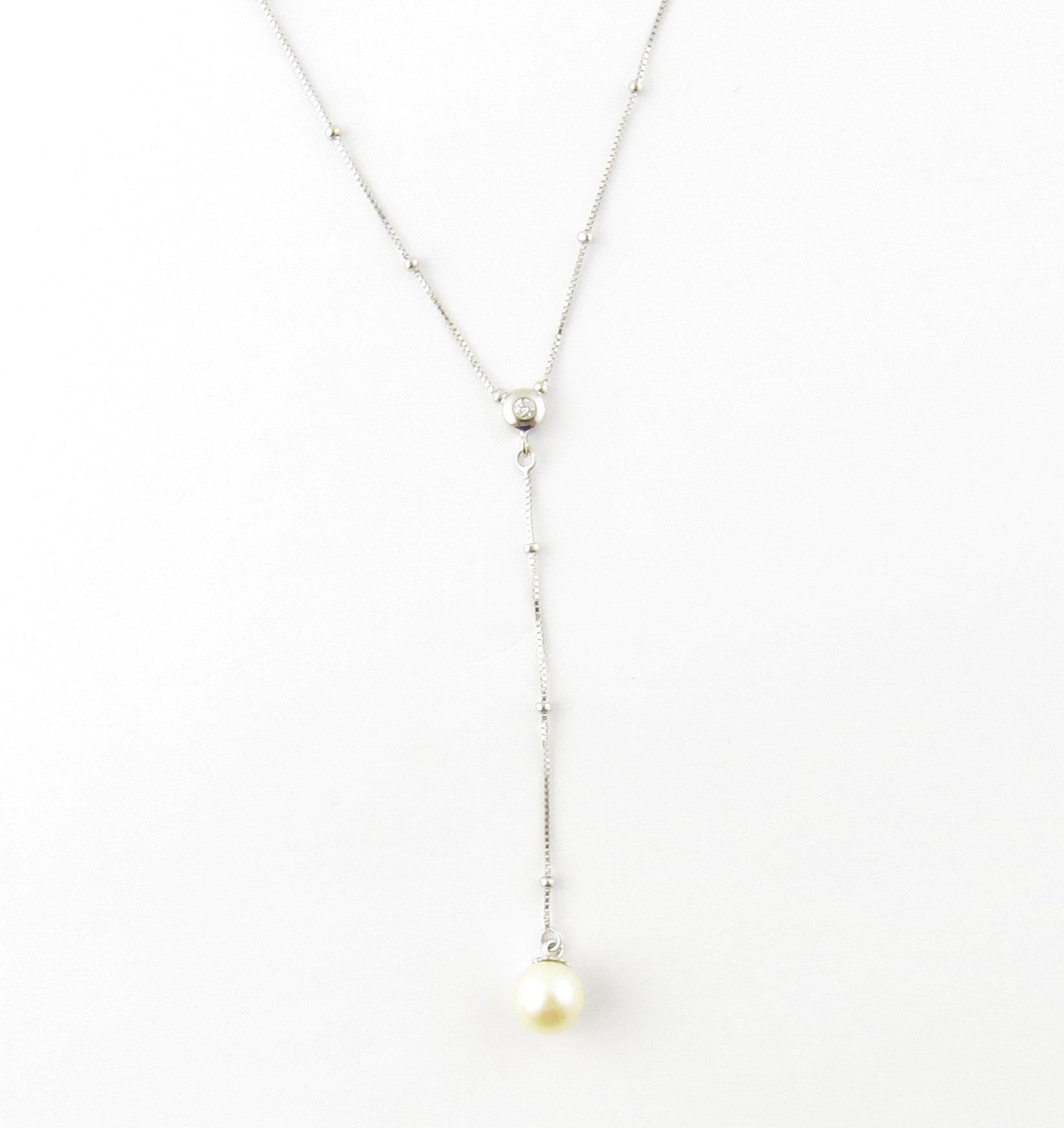 Vintage 14 Karat White Gold Diamond and Pearl Drop Necklace- 
This exquisite necklace is decorated with one round brilliant cut diamond and a luminous 7 mm cultured pearl drop on a stunning beaded necklace. 
Approximate total diamond weight: .03 ct.