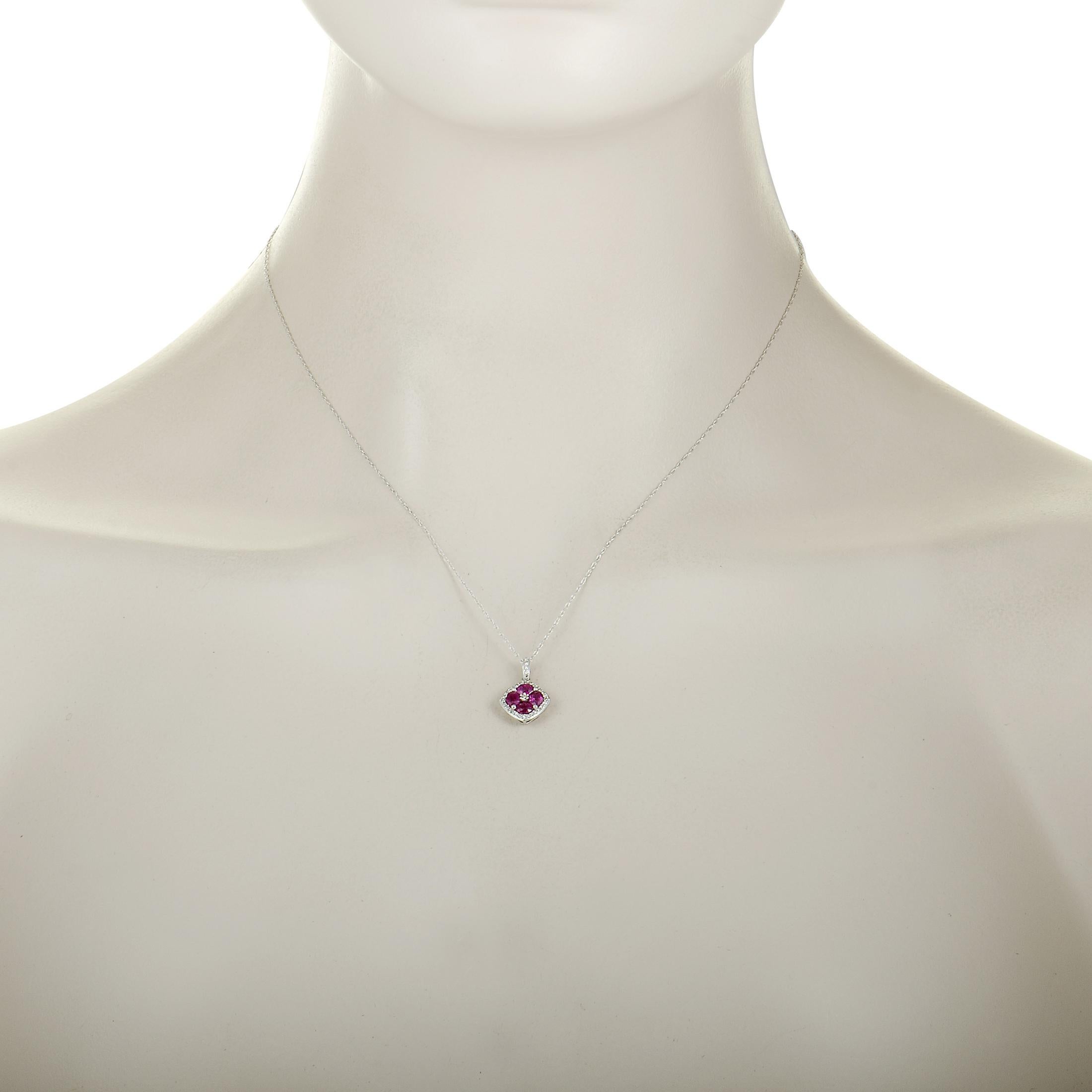 This necklace is made of 14K white gold and set with rubies and a total of 0.16 carats of diamonds. It has a 17.50” long chain with spring ring closure, while the pendant measures 0.62” in length and 0.45” in width. The necklace weighs 1.7 grams.
 
