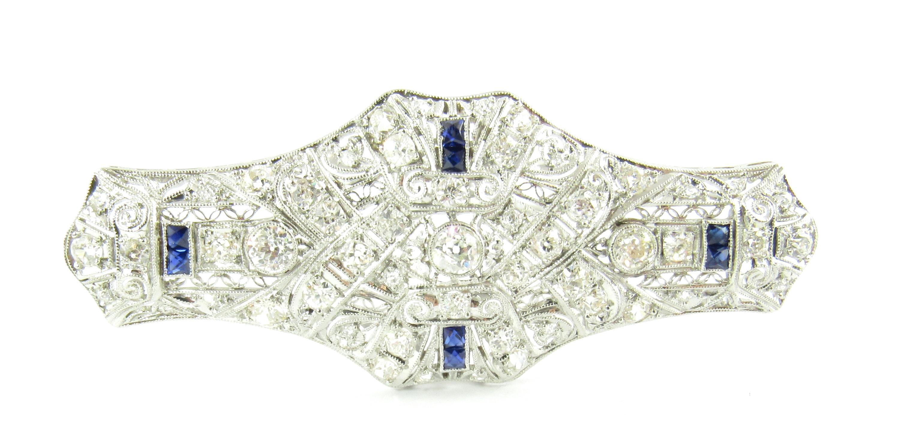 Vintage 14 Karat White Gold Diamond and Lab Created Sapphire Brooch/Pin-

This spectacular brooch features four rectangular blue sapphires and 48 European/Old Mine cut diamonds set in stunning white gold filigree.

Approximate total diamond weight: 