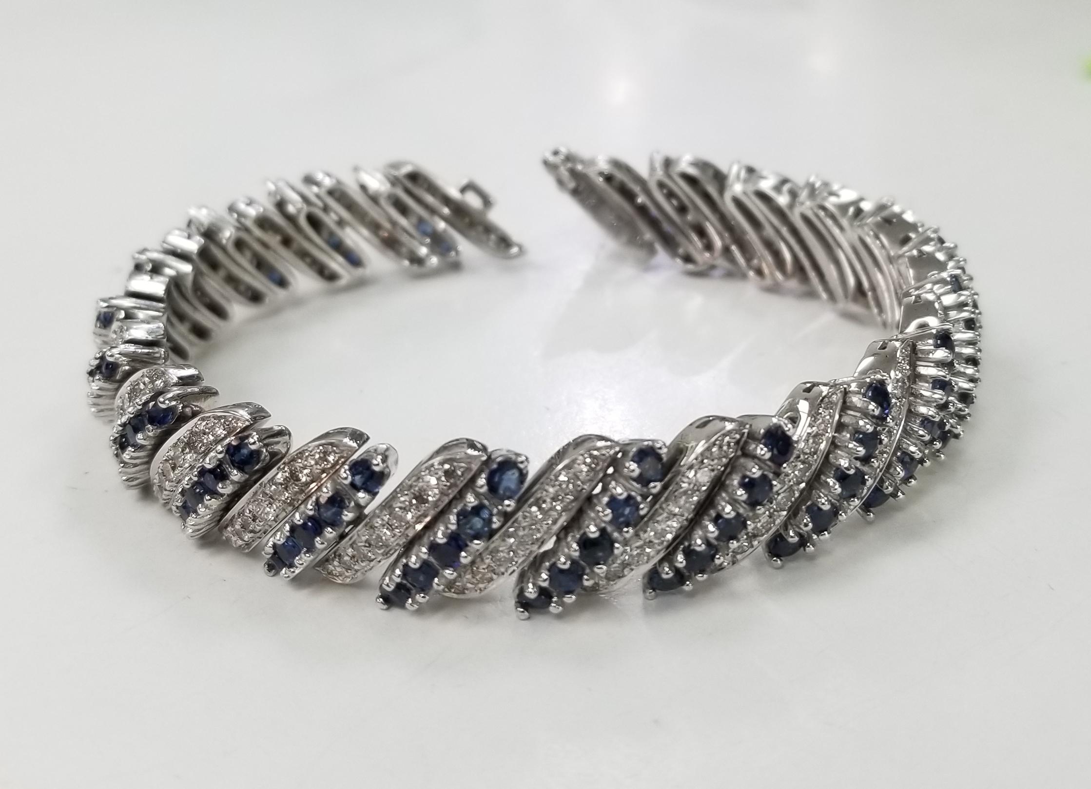 Circa 1960s 14 karat white gold Diamond and Sapphire flexible bracelet, containing 147 round full cut diamonds; color 