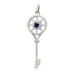 14 Karat White Gold Diamond and Sapphire Paved Key Pendant