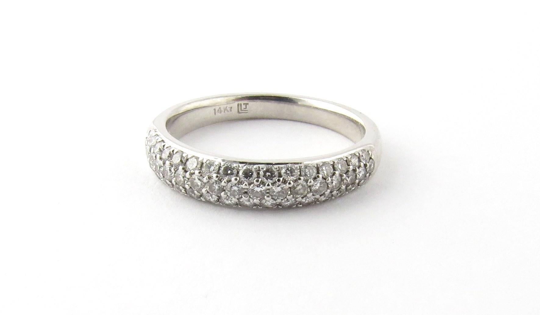 Vintage 14K White Gold Diamond Band Size 6.5 

This White Gold band has 3 rows of diamonds half way around the band. 

There are 49 round brilliant diamonds totally approximately .33 cts. Diamonds are of SI clarity and H color. 

The shank is 3 mm.