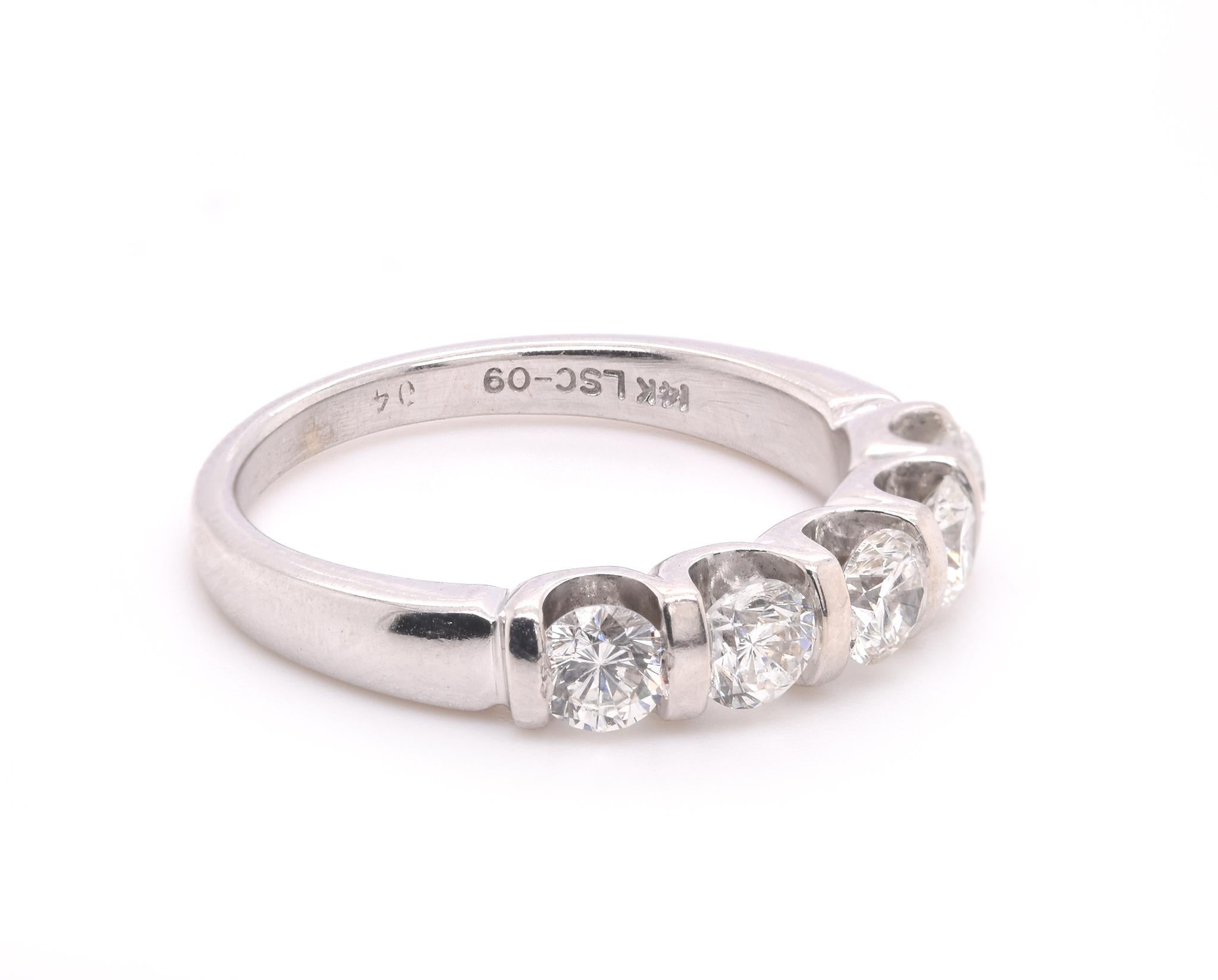 Designer: custom 
Material: 14K white gold
Diamonds: 5 round brilliant cut = 1.00cttw
Color: H
Clarity: VS1
Ring Size: 6.75
Dimensions: ring is 3mm wide
Weight: 4.20 grams