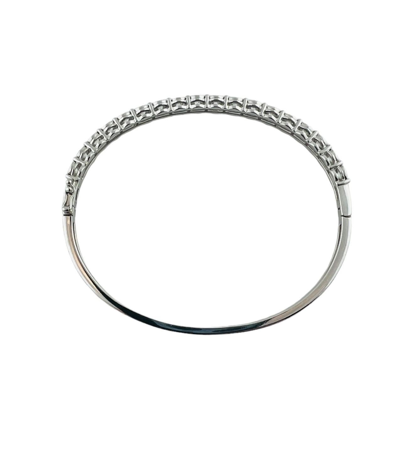 This sparkling hinged bangle bracelet features 18 round brilliant cut diamonds set classic 14K white gold. Width: 5 mm.

Total diamond weight:   2.14  ct.

Diamond color:  I

Diamond clarity:  SI2-I1

Size: 6.5 inches

Weight:   10.5 gr./  6.8