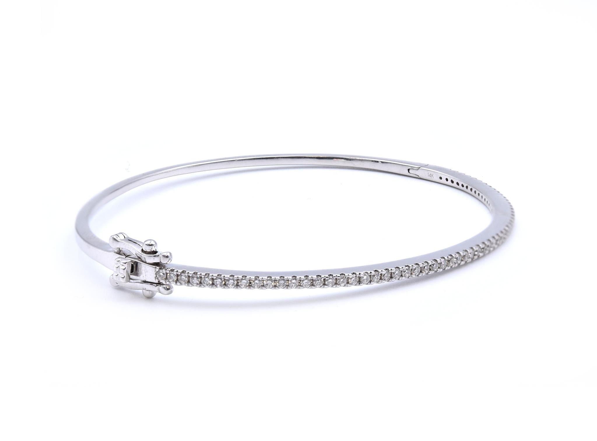 Material: 14K white gold 
Diamonds: 52 round brilliant cut = .52cttw
Color: G
Clarity: VS
Dimensions: bracelet will fit up to a 7-inch wrist
Weight: 8.60 grams