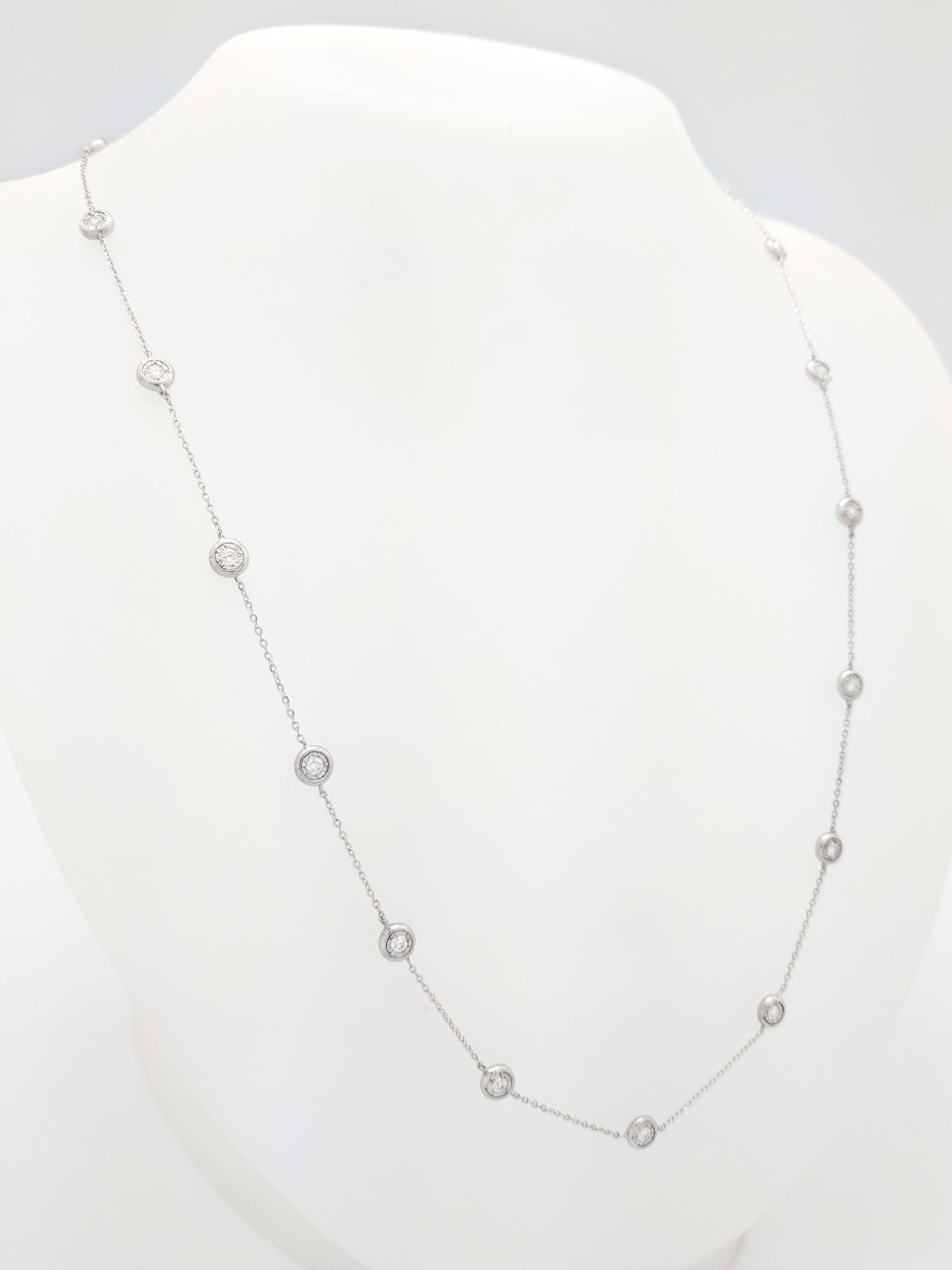 You are viewing a Stunning Diamond By The Yard Necklace. The necklace is crafted from 14k white gold and weighs 5.9 grams. It features twenty-one bezel set round brilliant diamond for an estimated .93tcw. The diamonds range from G-H in color and are