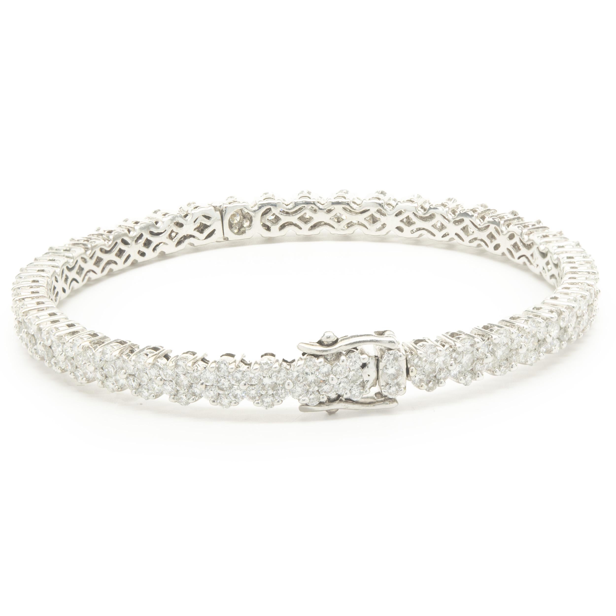 Designer: custom
Material: 14K white gold 
Diamond: 298 round brilliant cut = 5.50cttw
Color: G
Clarity: VS2
Weight: 16.52
Dimensions: bracelet will fit up to a 6.5-inch wrist