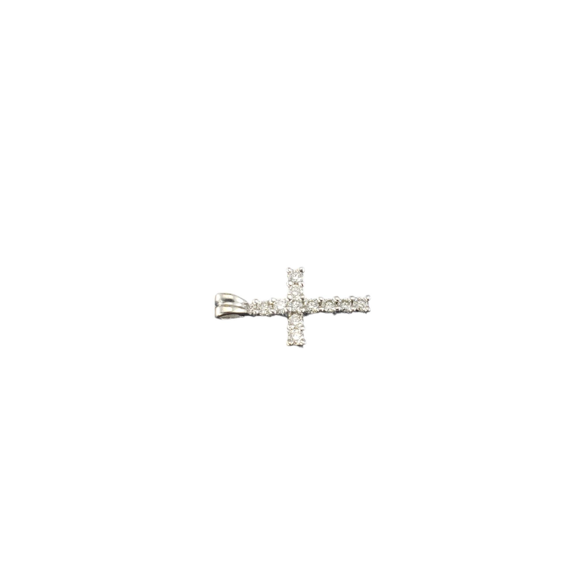 14 Karat White Gold Diamond Cross Pendant-

This sparkling cross pendant features 11 round brilliant cut diamonds set in classic 14K white gold.  

Approximate total diamond weight: .22 ct.

Diamond color: J-K

Diamond clarity: VS

Size: 19 mm x
