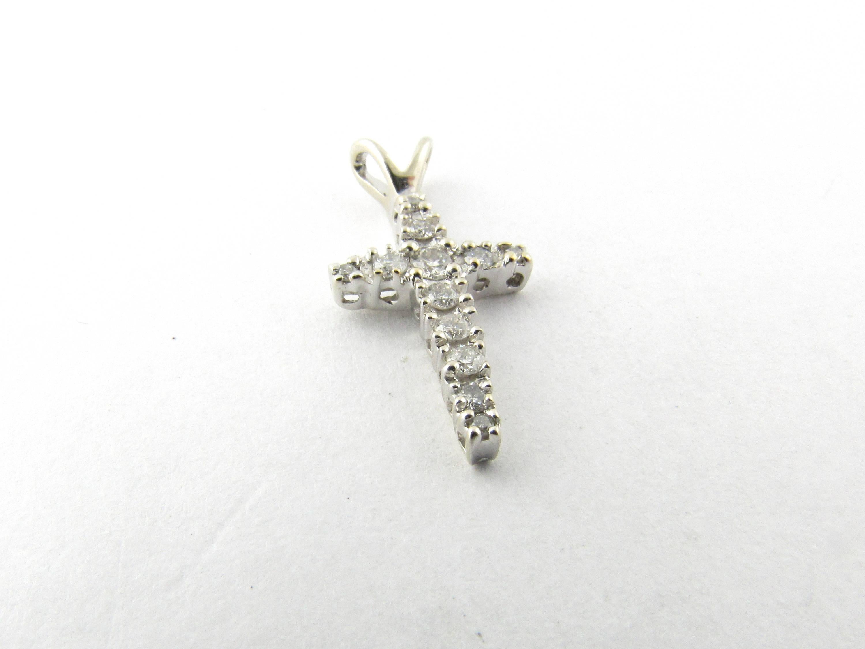 Vintage 14 Karat White Gold Diamond Cross Pendant-

This sparkling cross pendant features 12 graduated round brilliant cut diamonds set in meticulously detailed 14K white gold.

Approximate total diamond weight: .20 ct.

Diamond color: J

Diamond